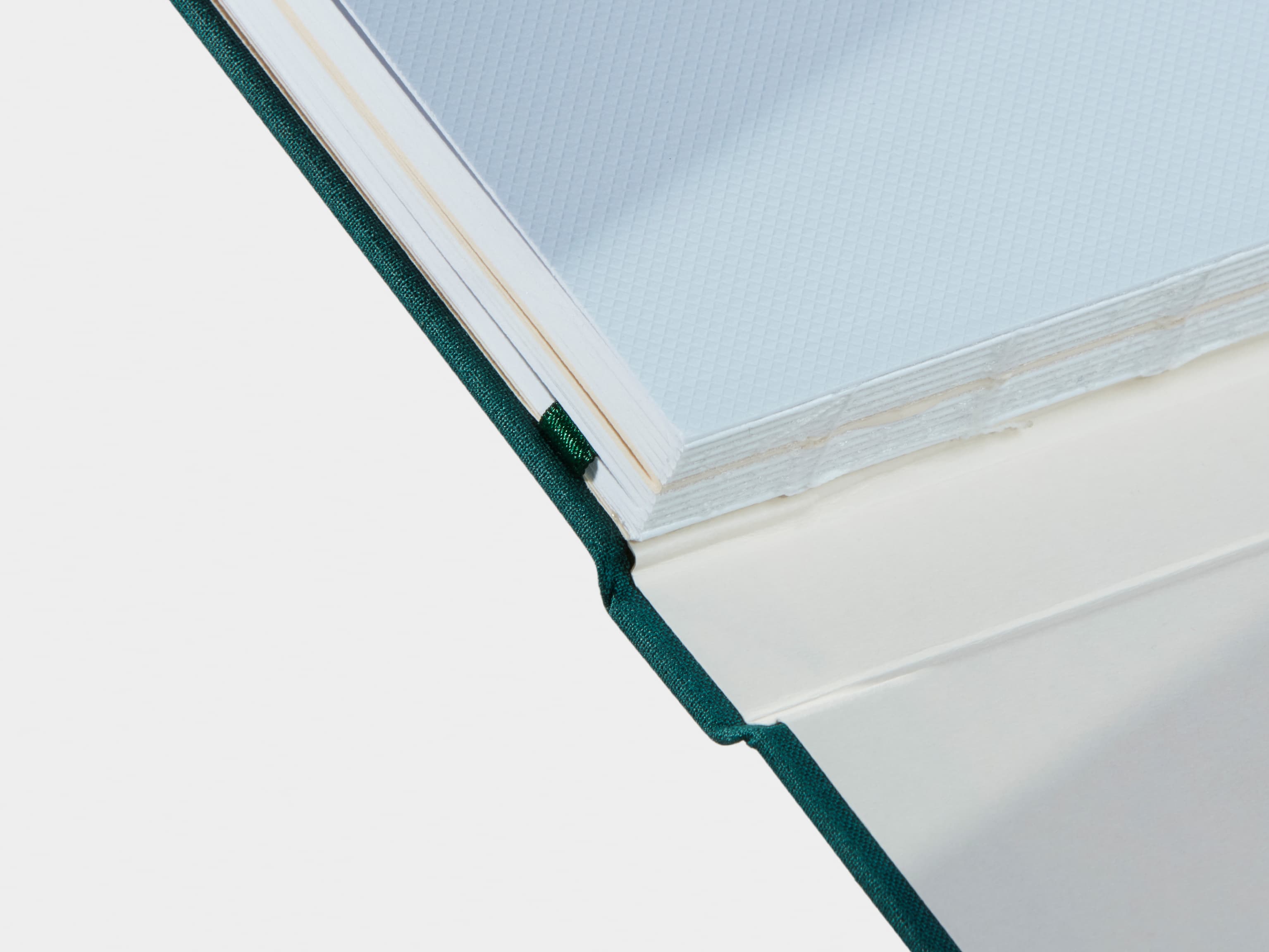 A close up of an Alpine Green Hardcover Notebook spine