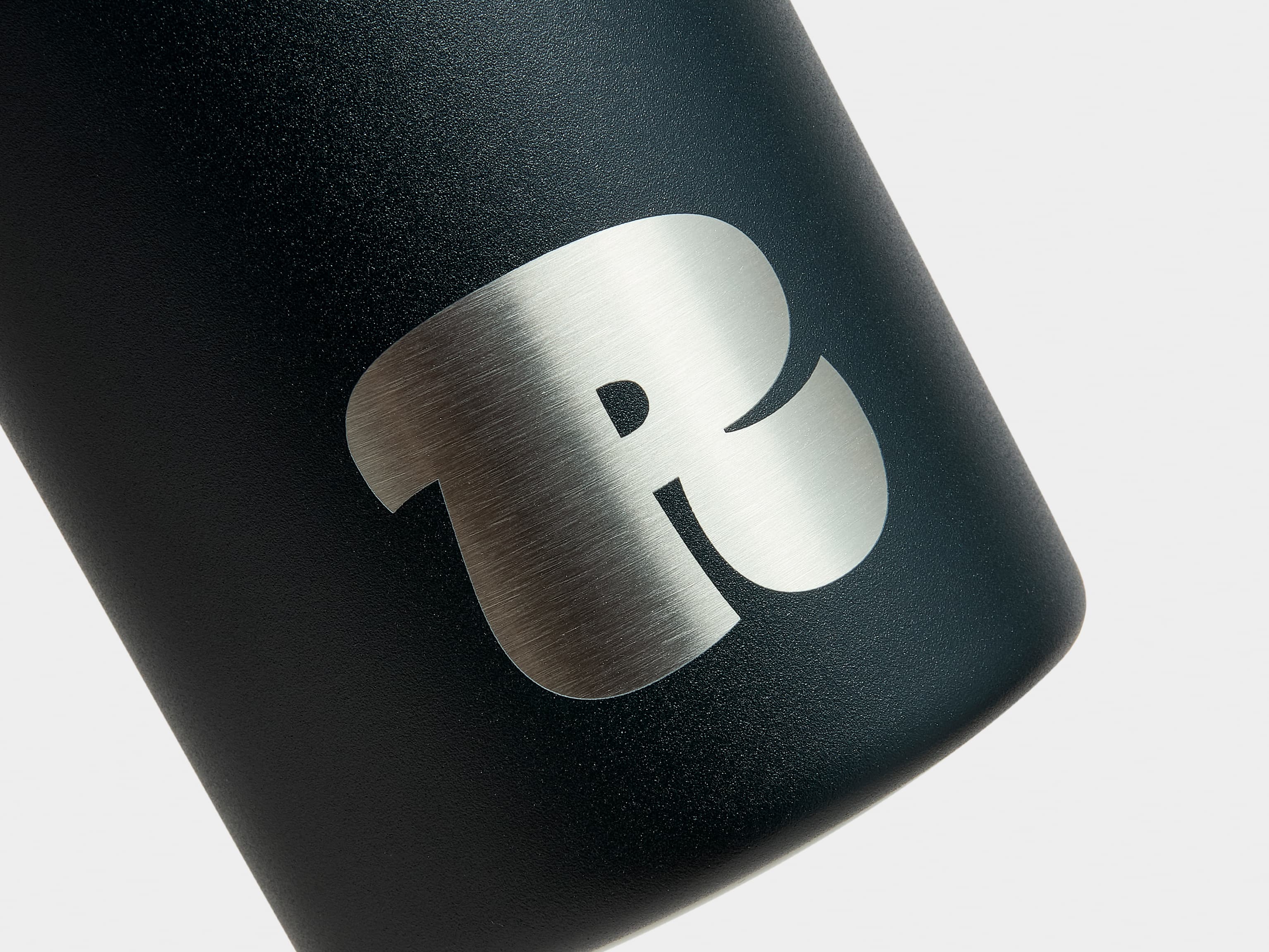 A close up image of the engraving customization on a jet black MOO water bottle.