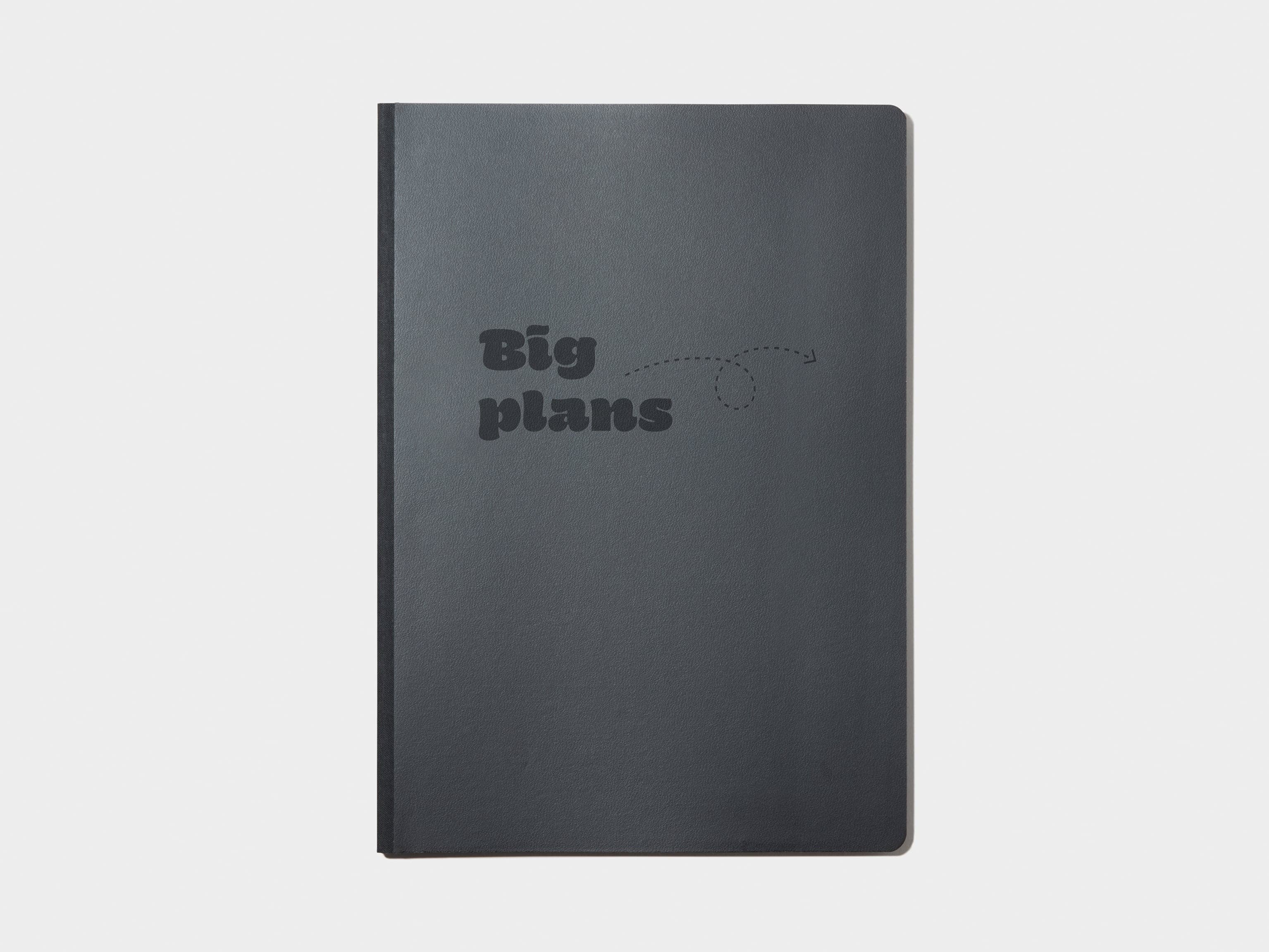 A black softcover planner with custom branding in deboss.