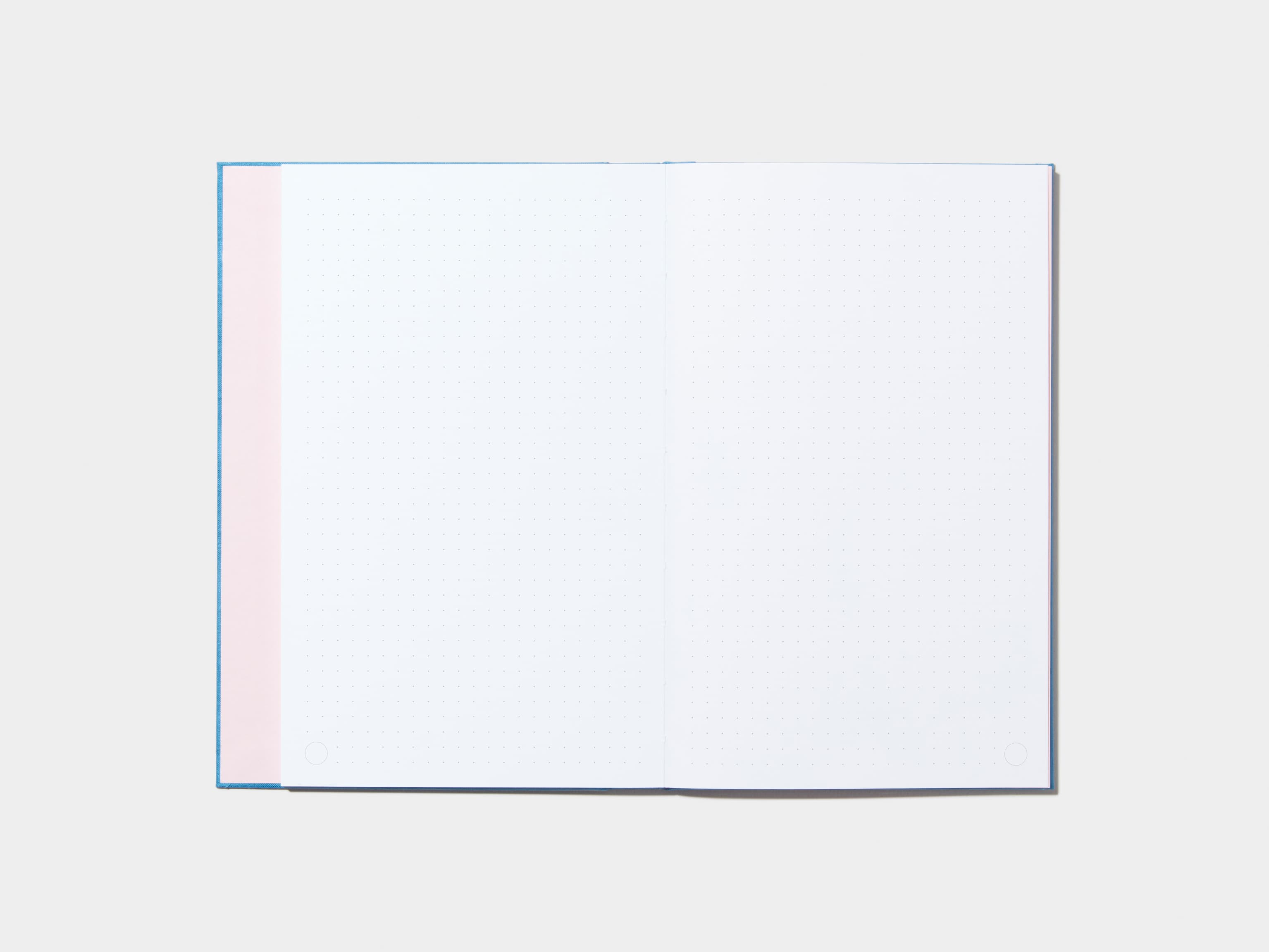 An opened Sky Blue Hardcover Notebook with dotted pages 