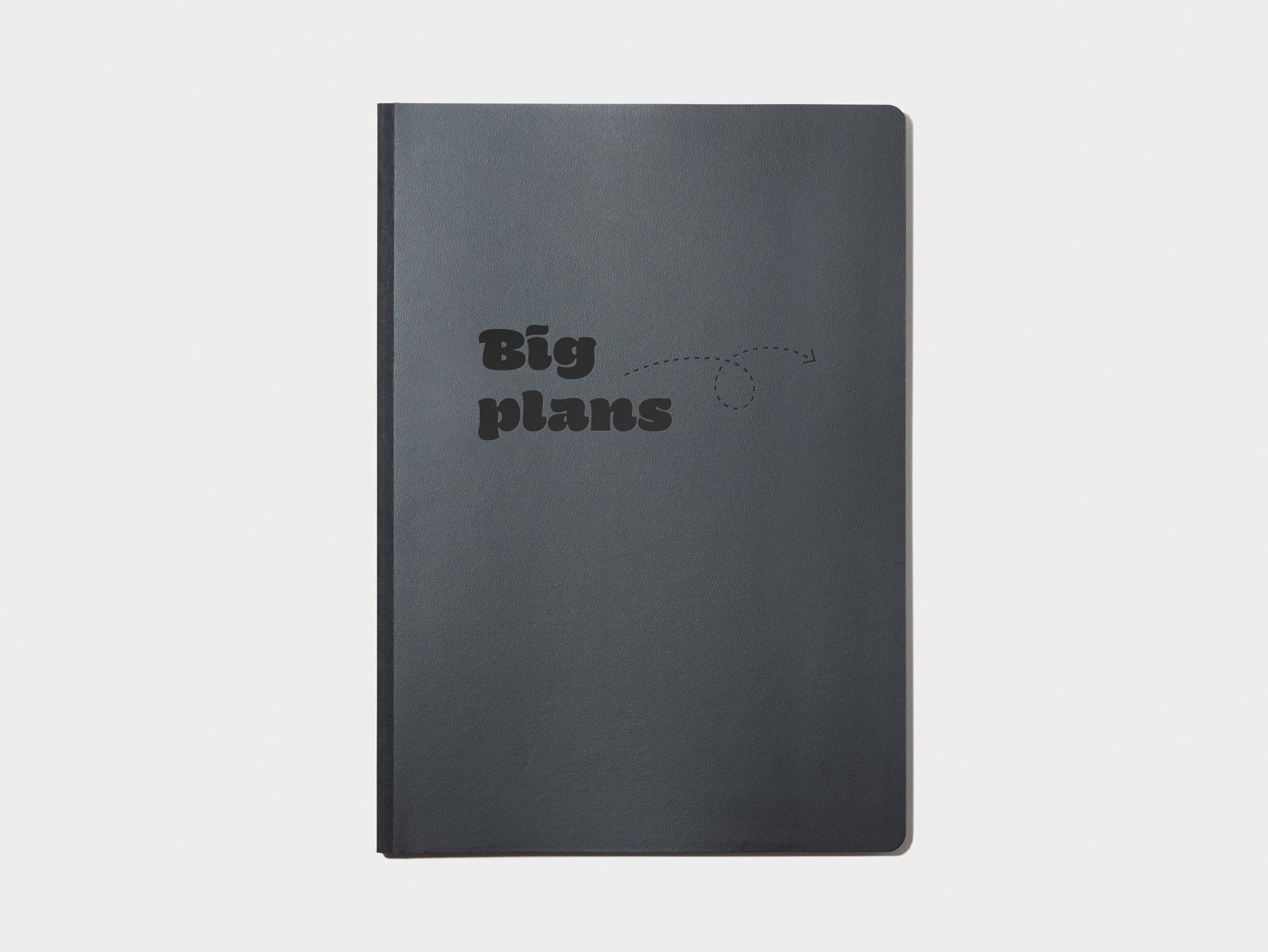 A black softcover planner with custom branding in black foil.