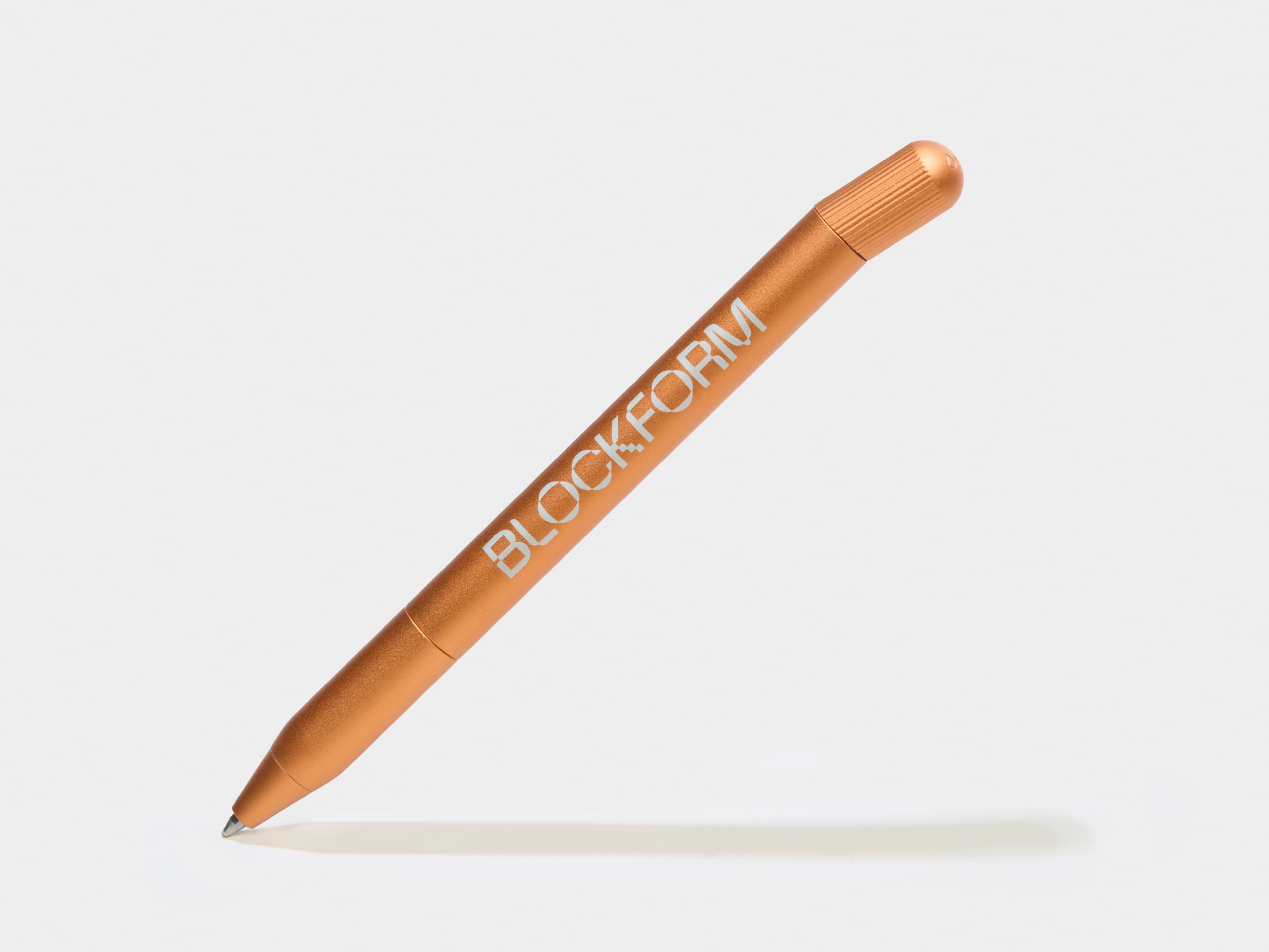 A orange pen with silver custom branding.