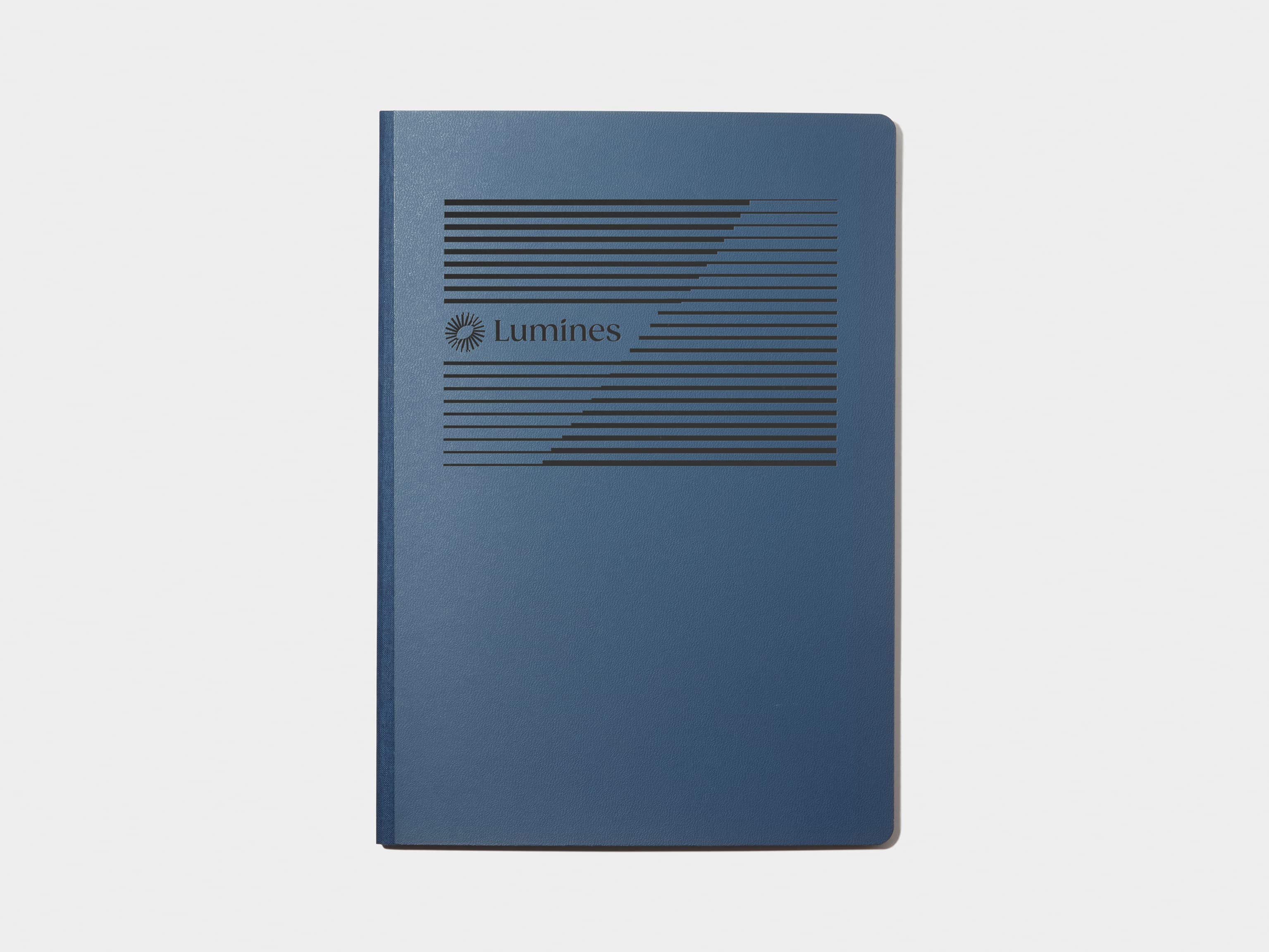 A large midnight blue softcover notebook with customised black foil.