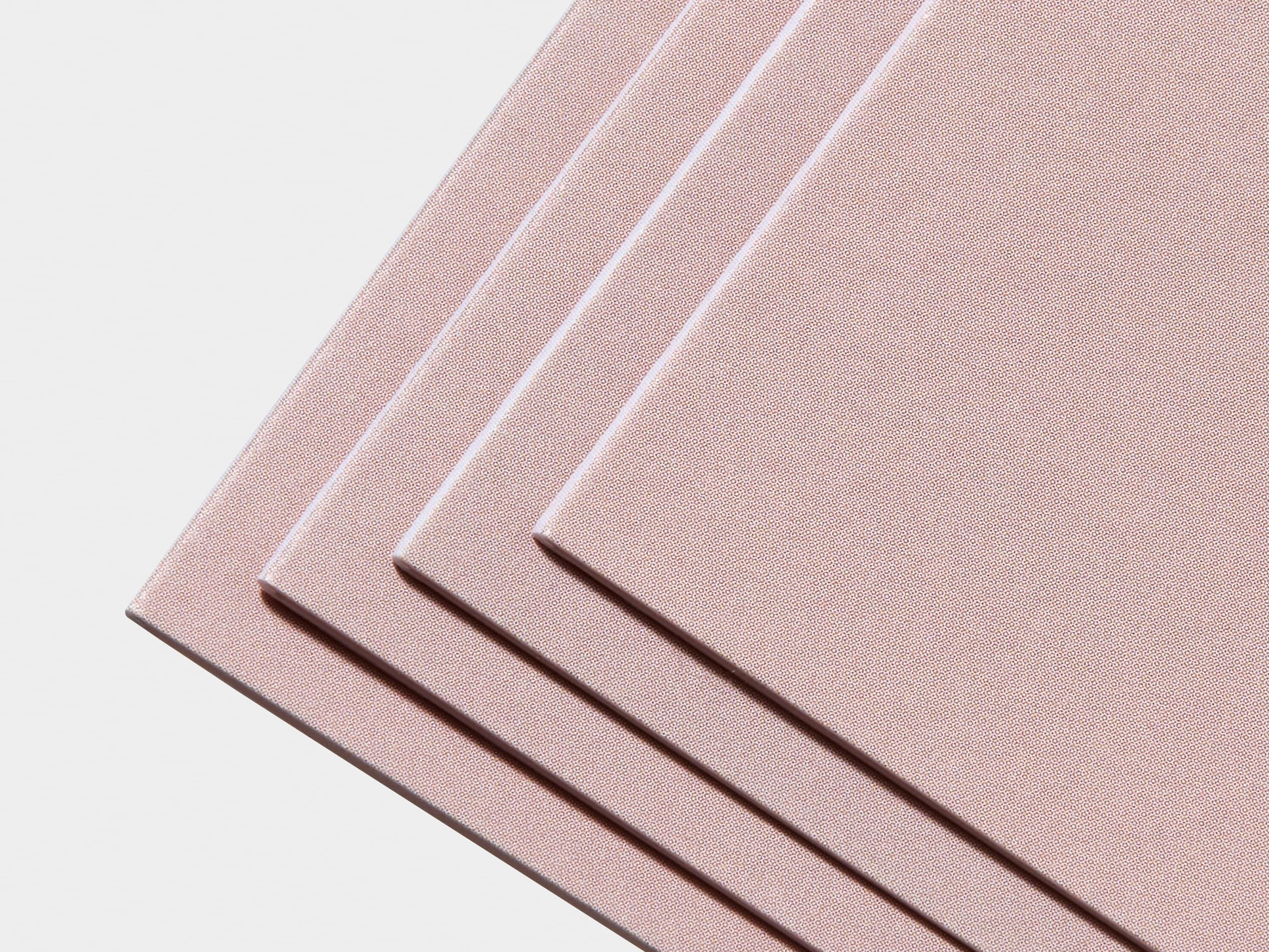 A detail image of the corner of a collection of matte bi-fold brochures.