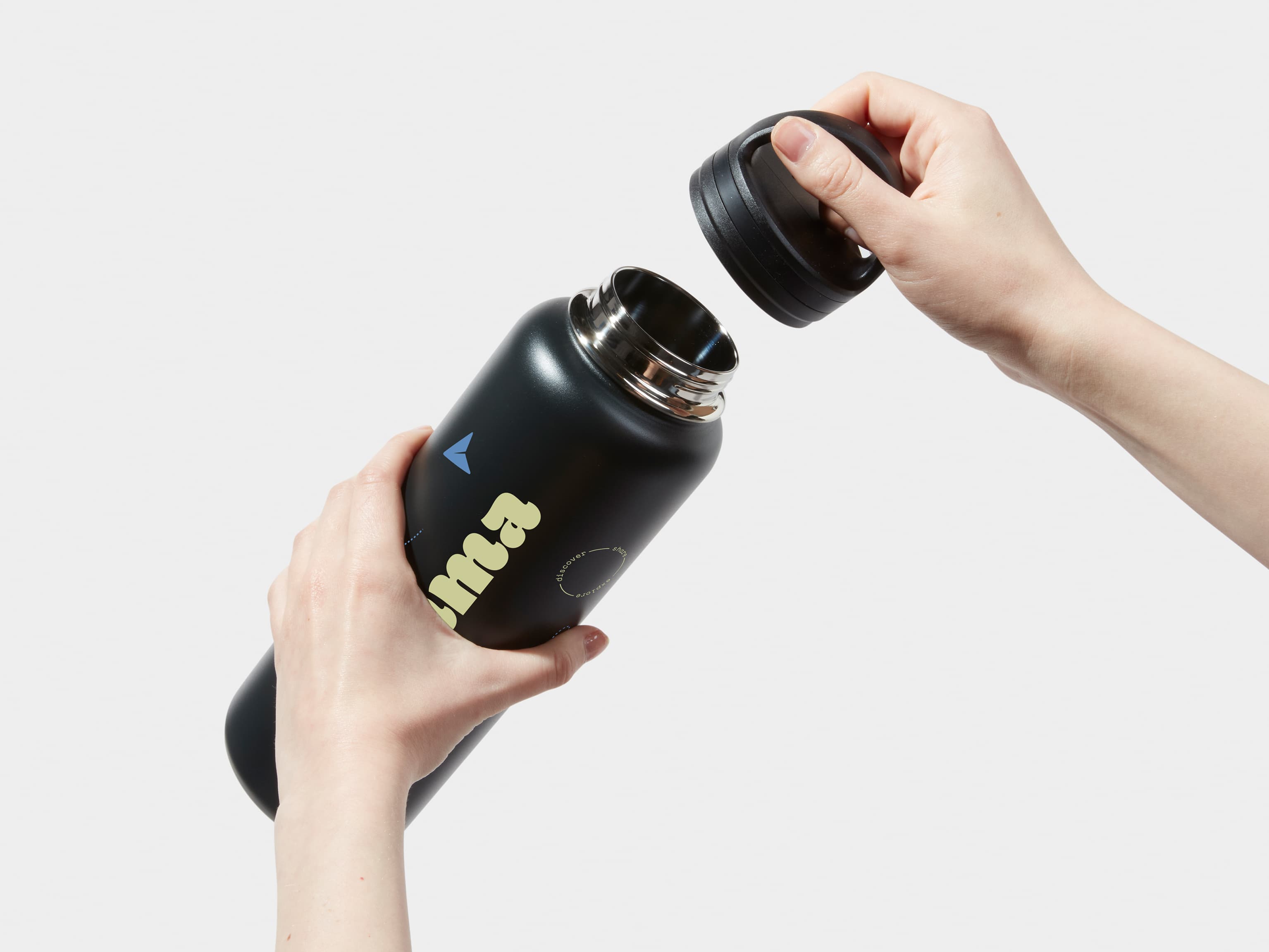 Two hands taking off the lid of a XL Insulated Water Bottle in Jet Black with 360 wrap printing customisation