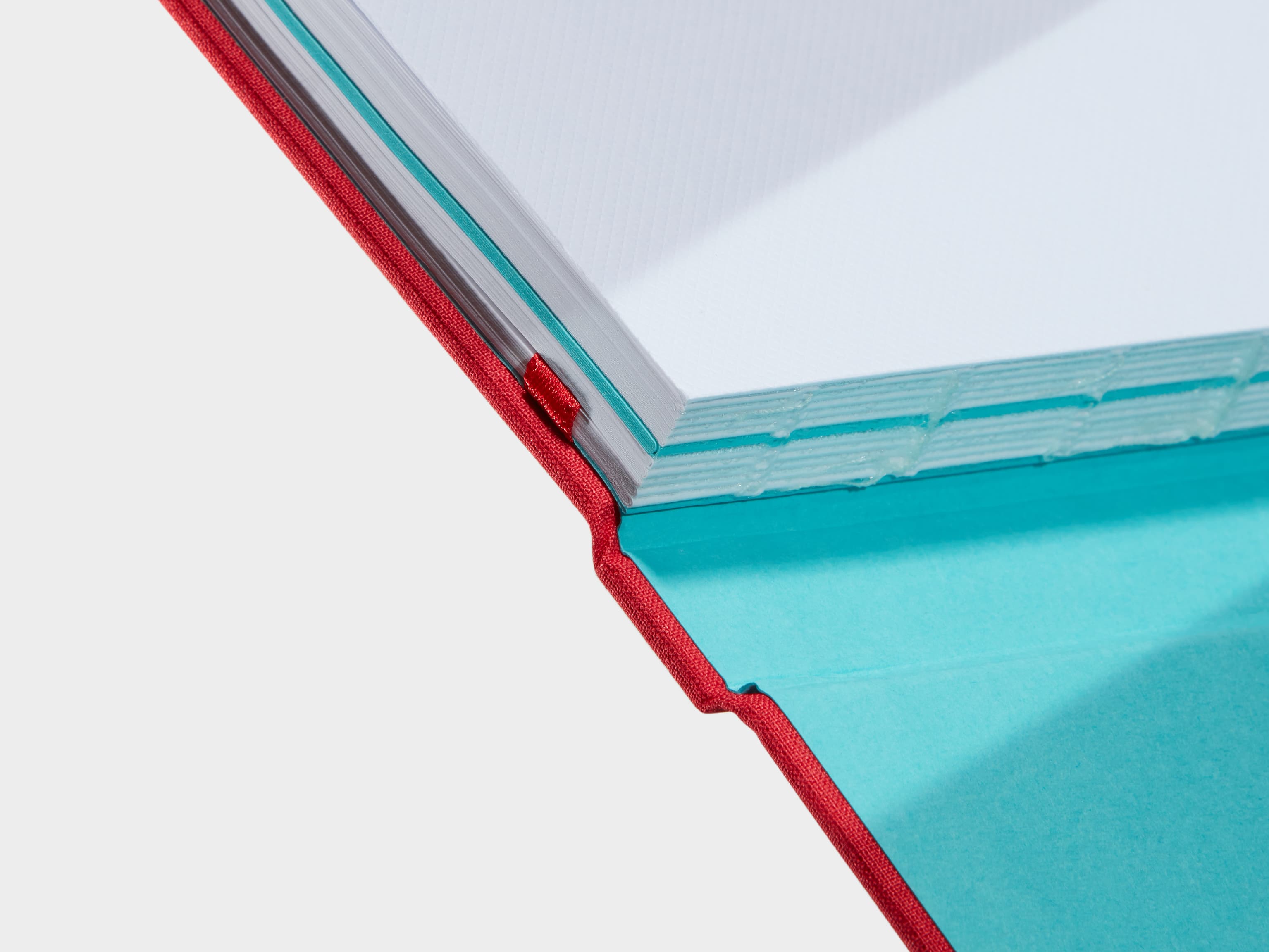 A close up of a Berry Red Hardcover Notebook spine