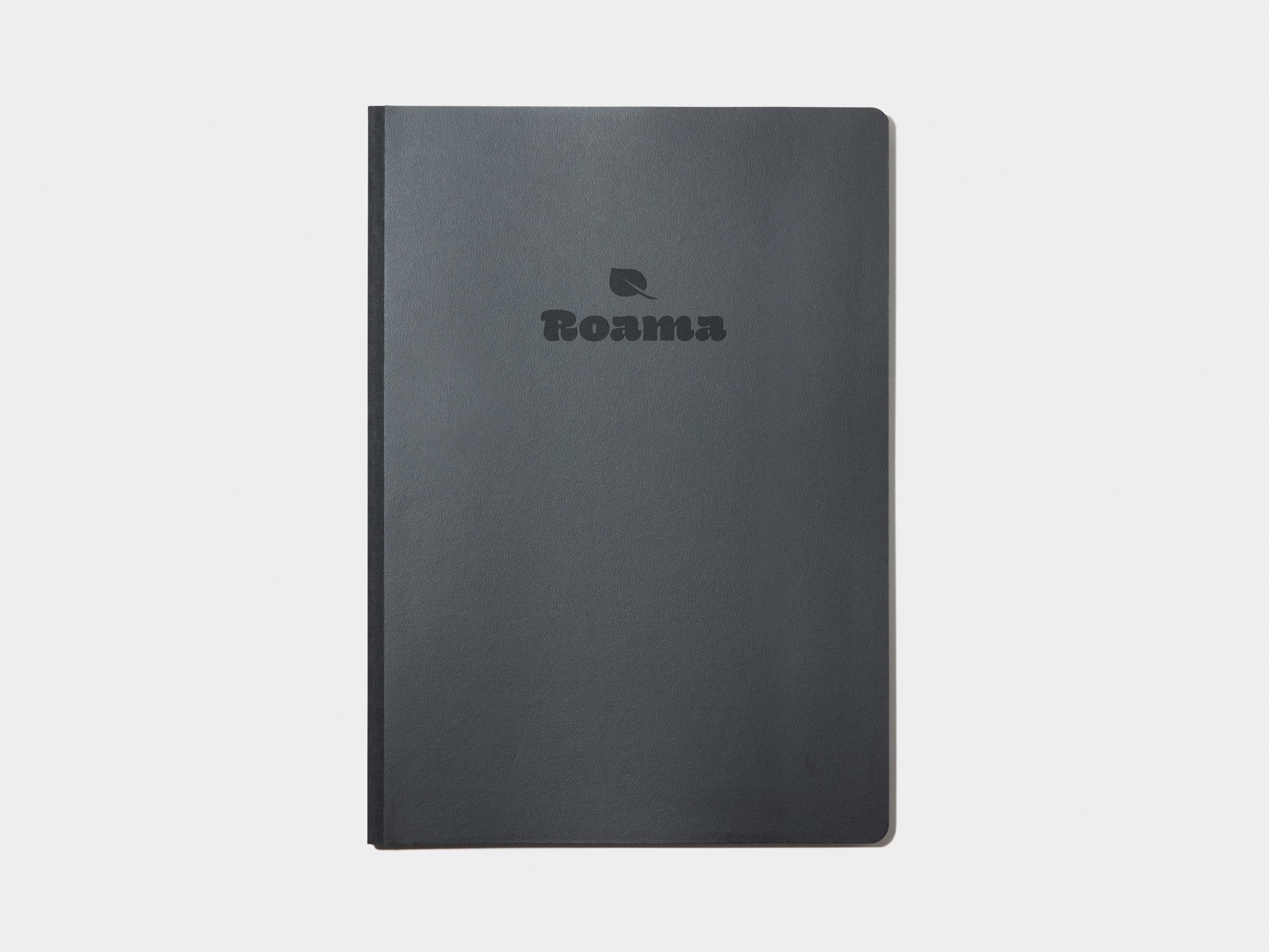 A large jet black softcover notebook with custom deboss.