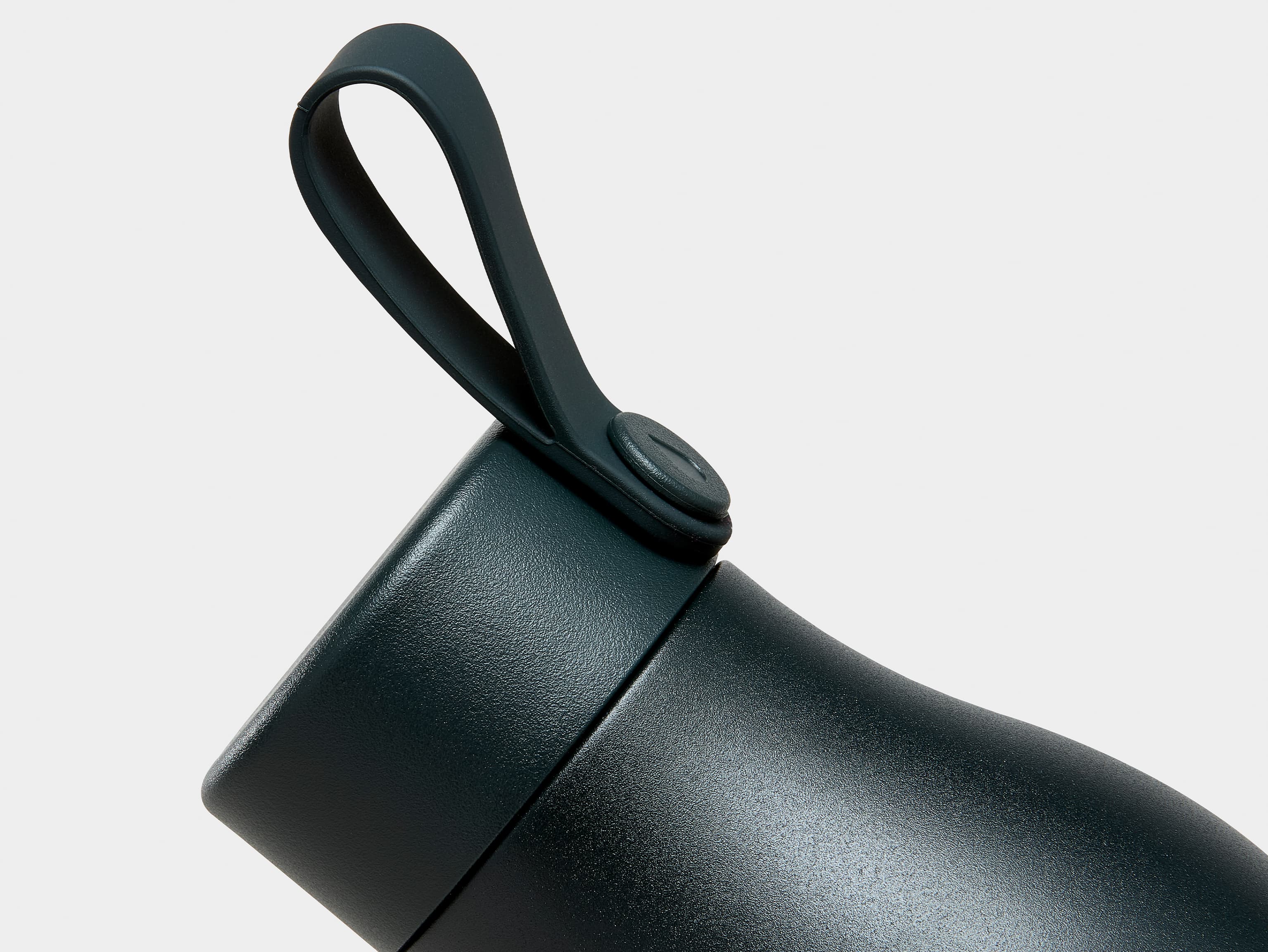 A close up image of the top of a jet black MOO water bottle.