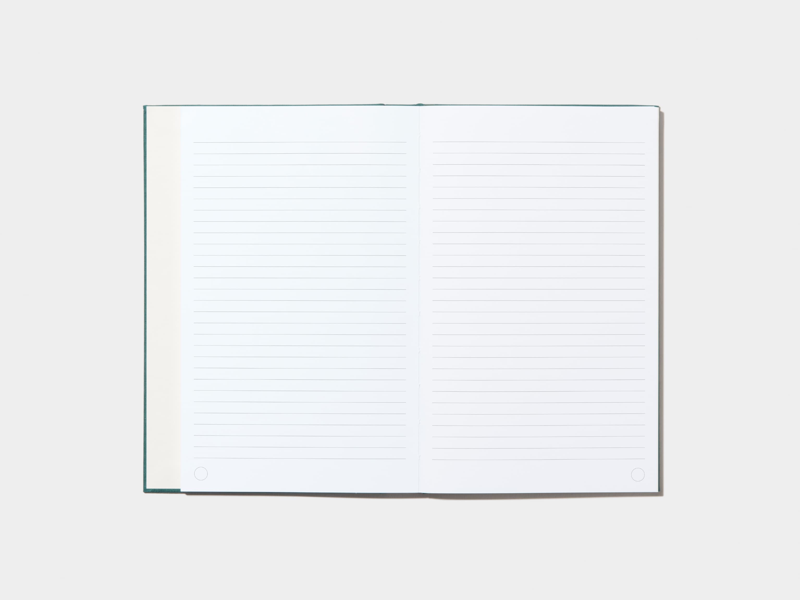 An opened Alpine Green Hardcover Notebook with lined pages 