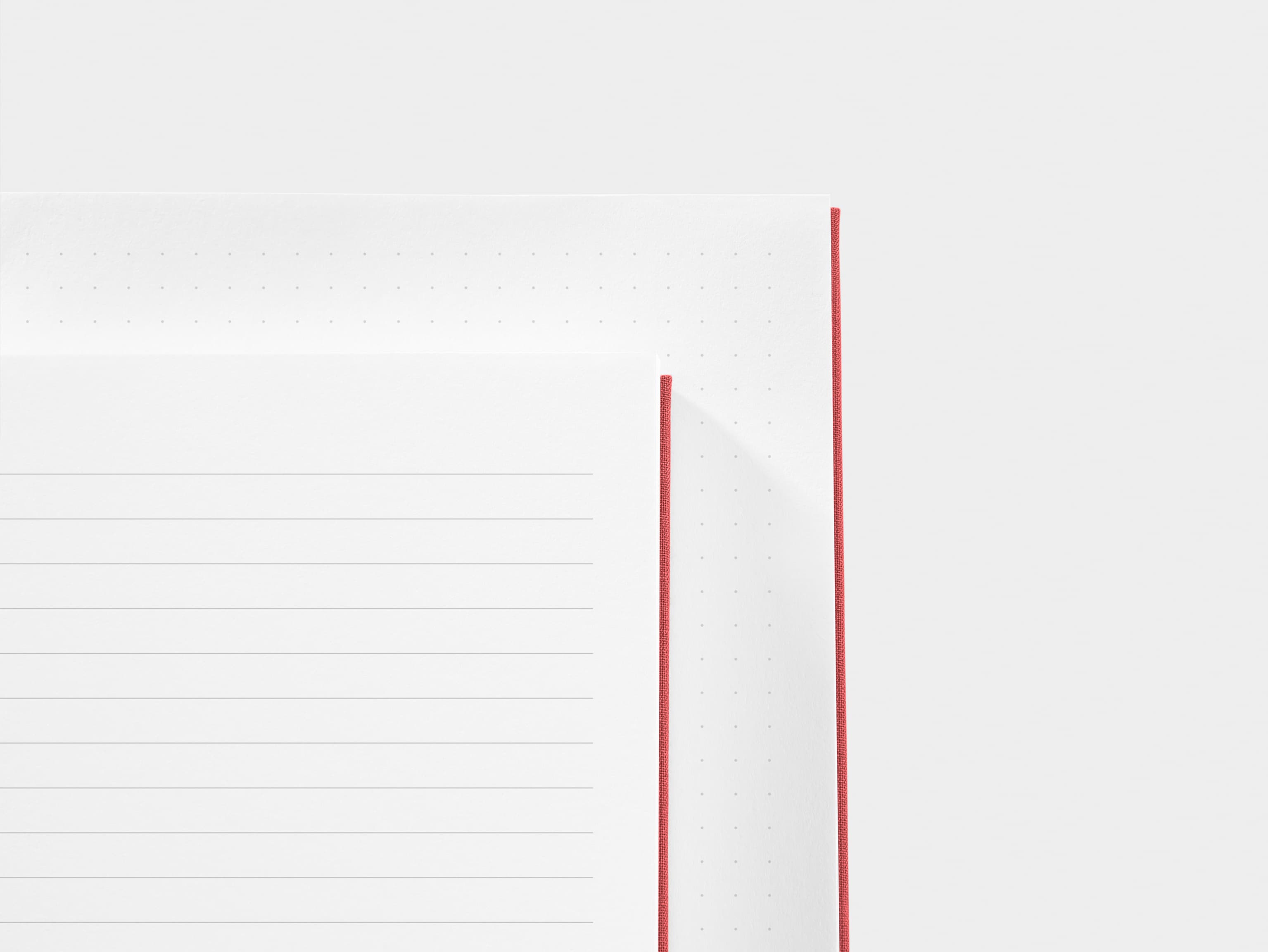 A close up of a dotted paper and a lined paper next to each other 