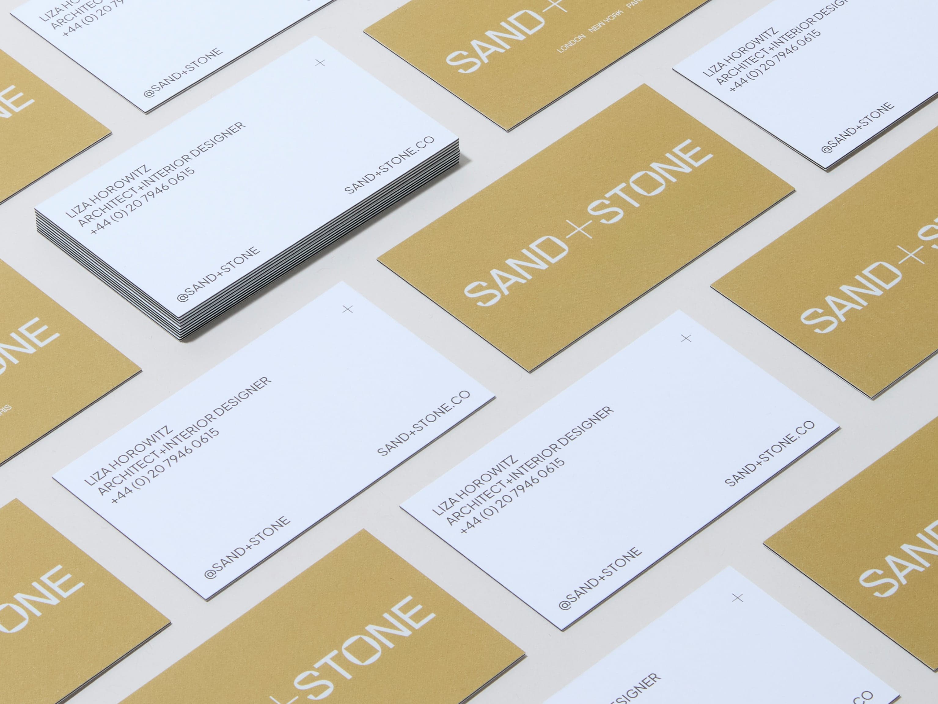 A collection of customised luxe business cards placed across the image.