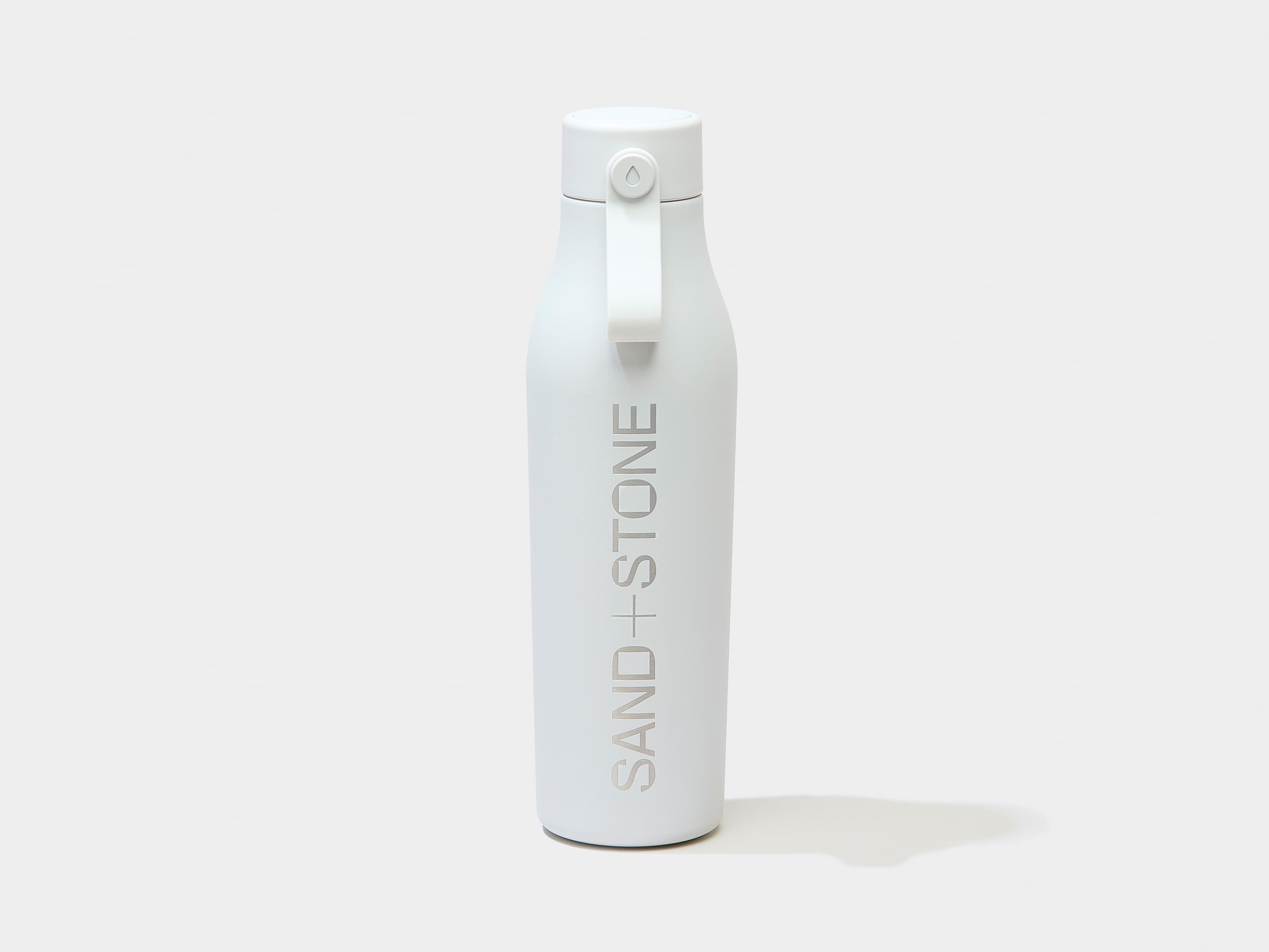 A cloud grey water bottle with custom silver branding.