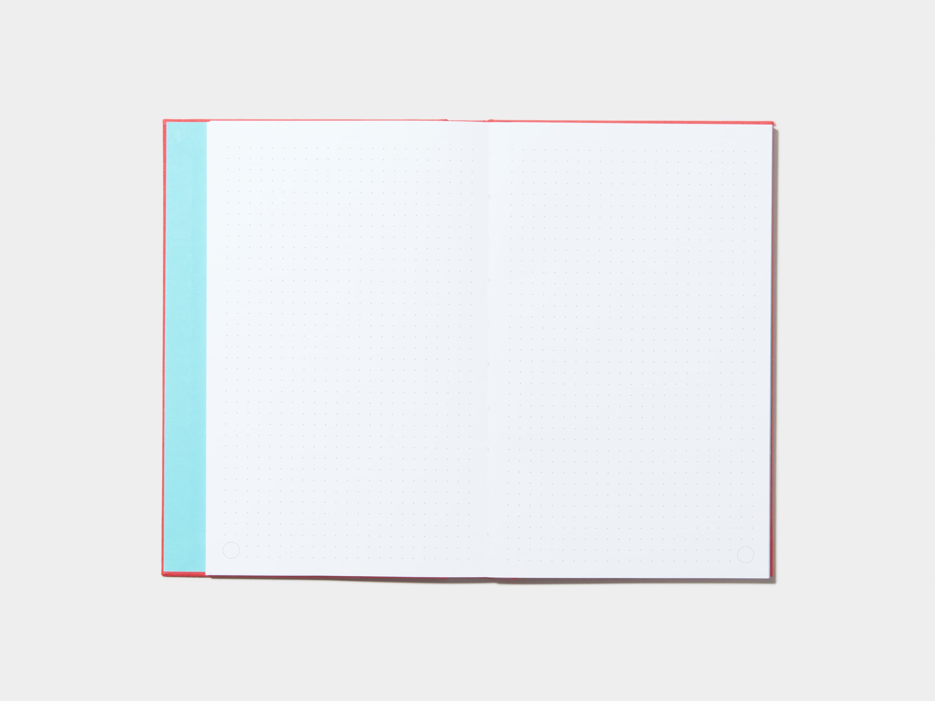 An opened Berry Red Hardcover Notebook with dotted pages 