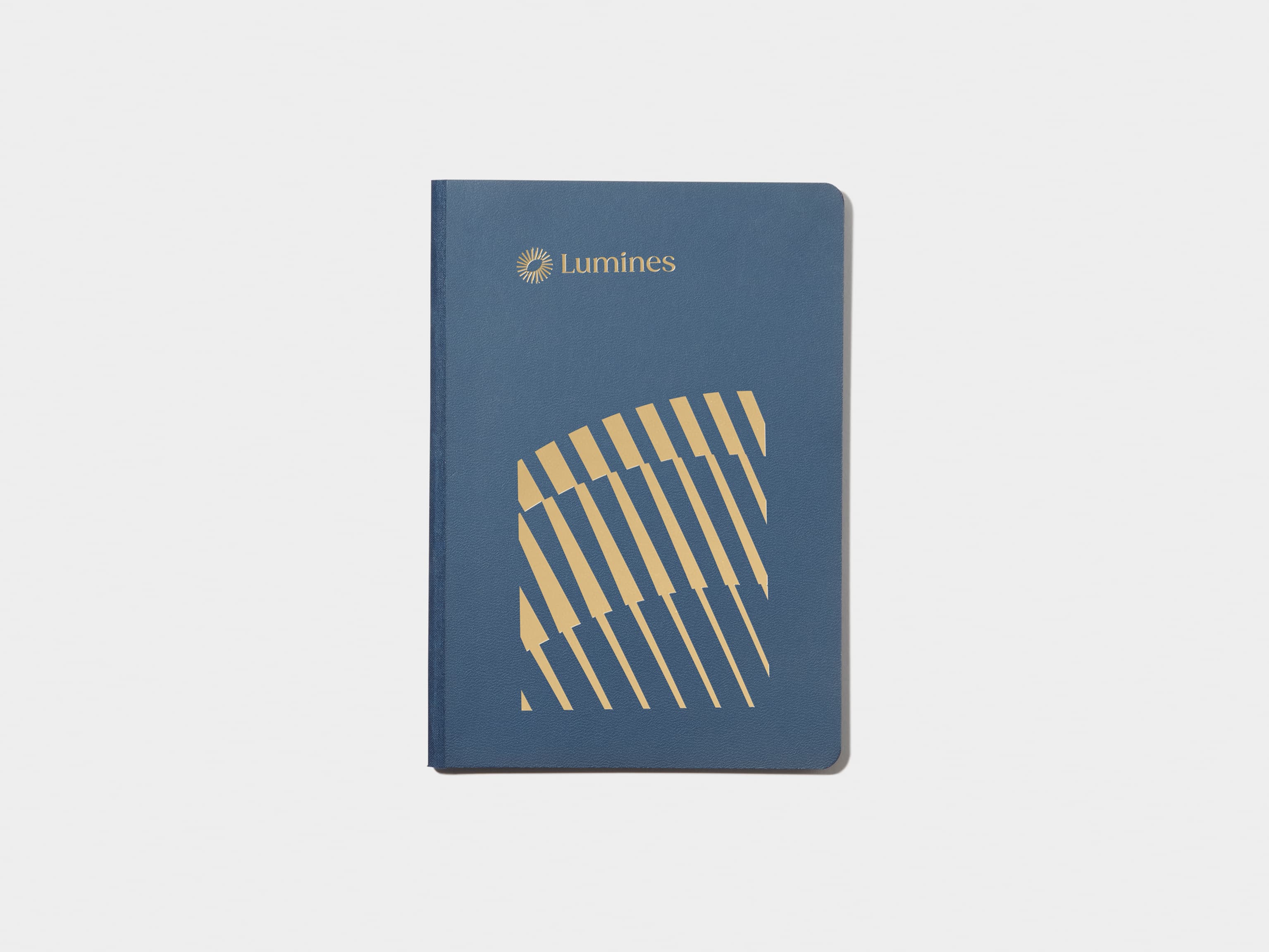 A midnight blue softcover notebook with gold foil customisation.