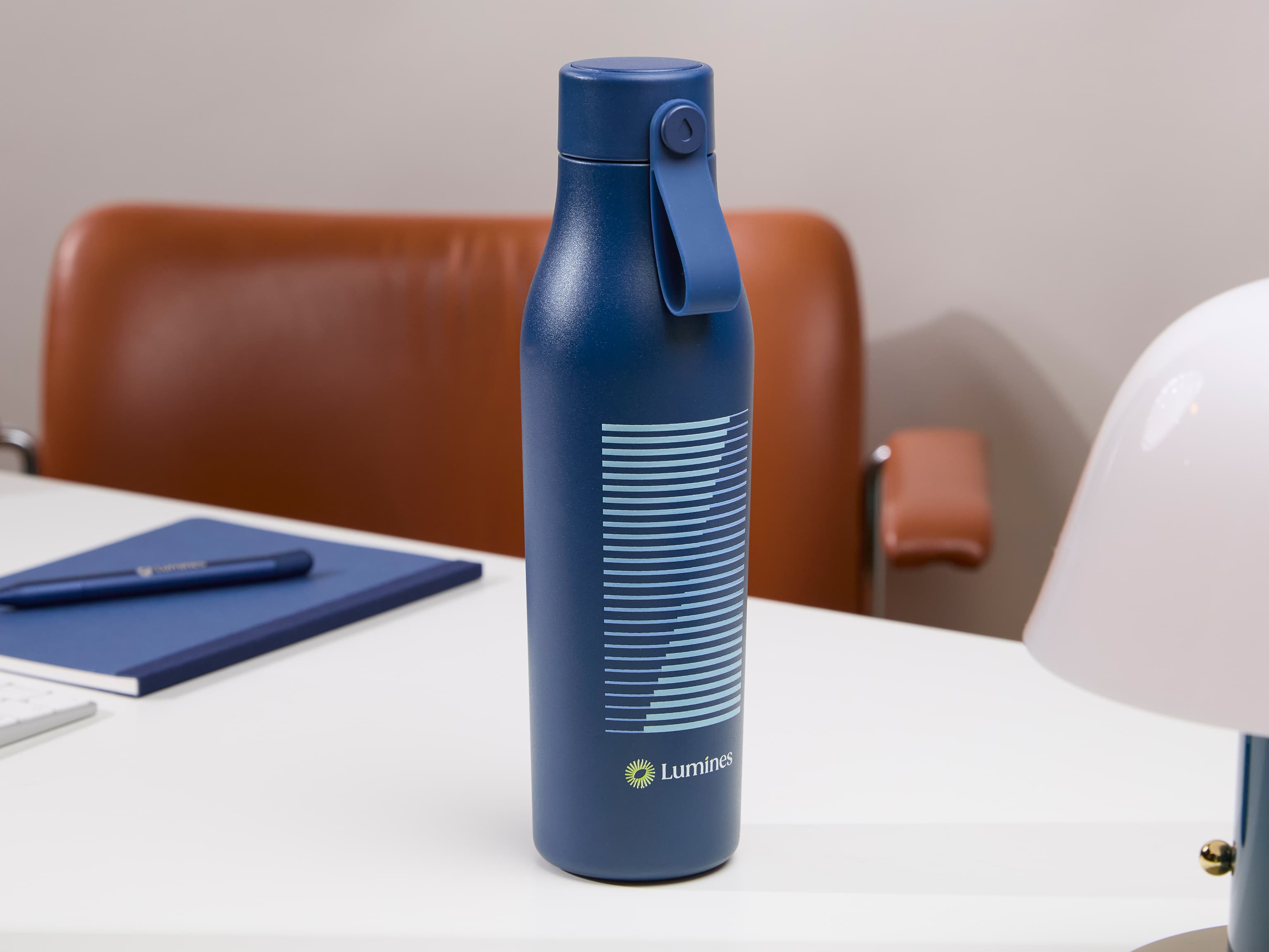 A blue water bottle with custom branding.