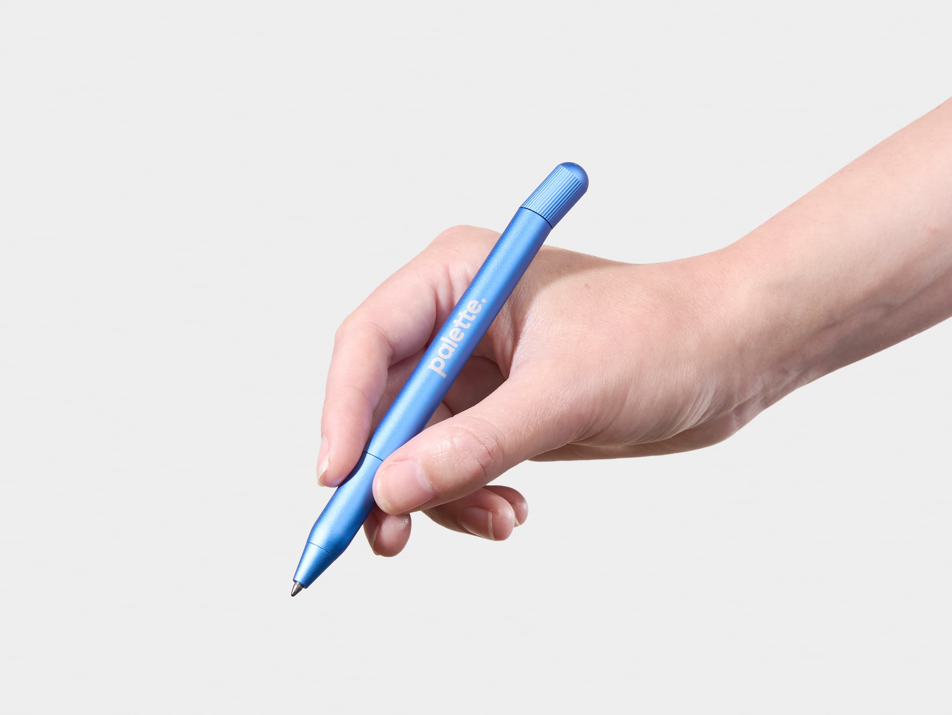 Person holding a custom blue pen.