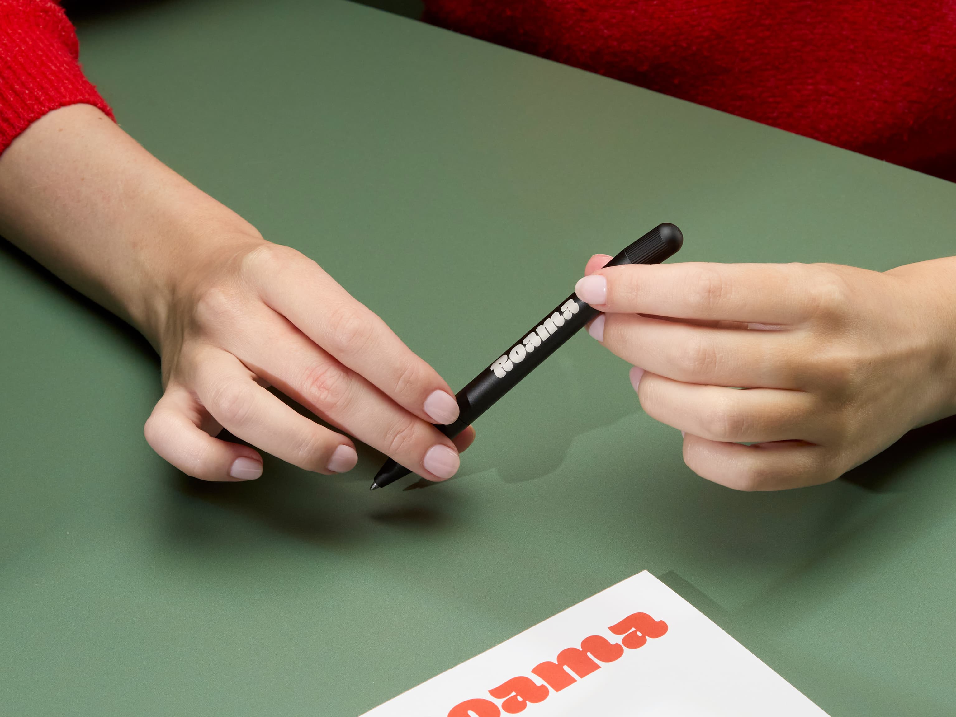 Person holding a custom black pen.