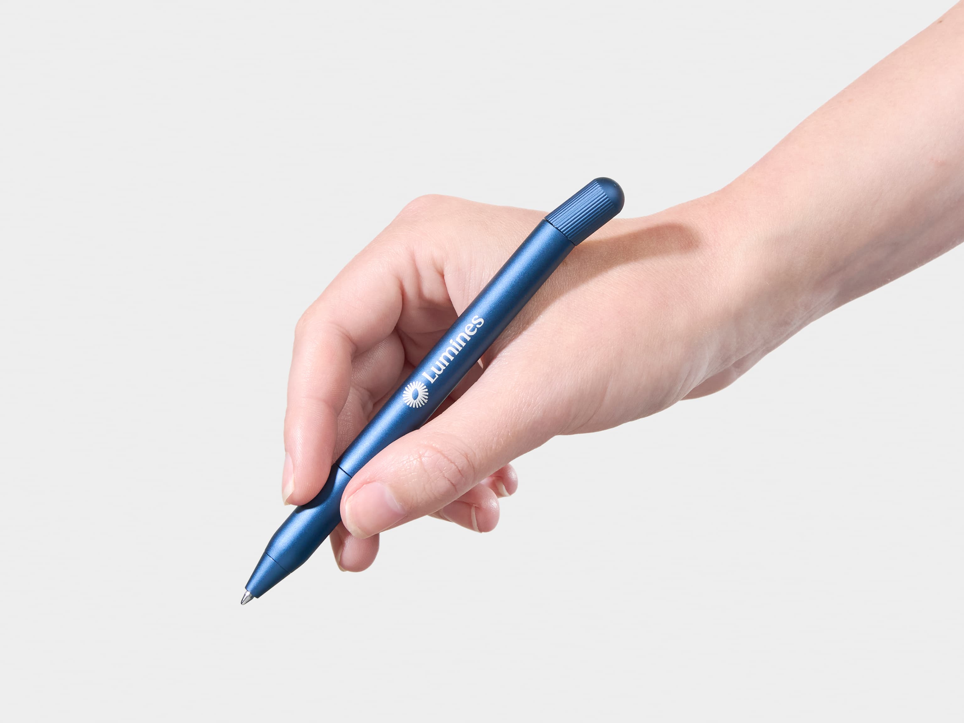 A person holding a blue pen with white custom branding.