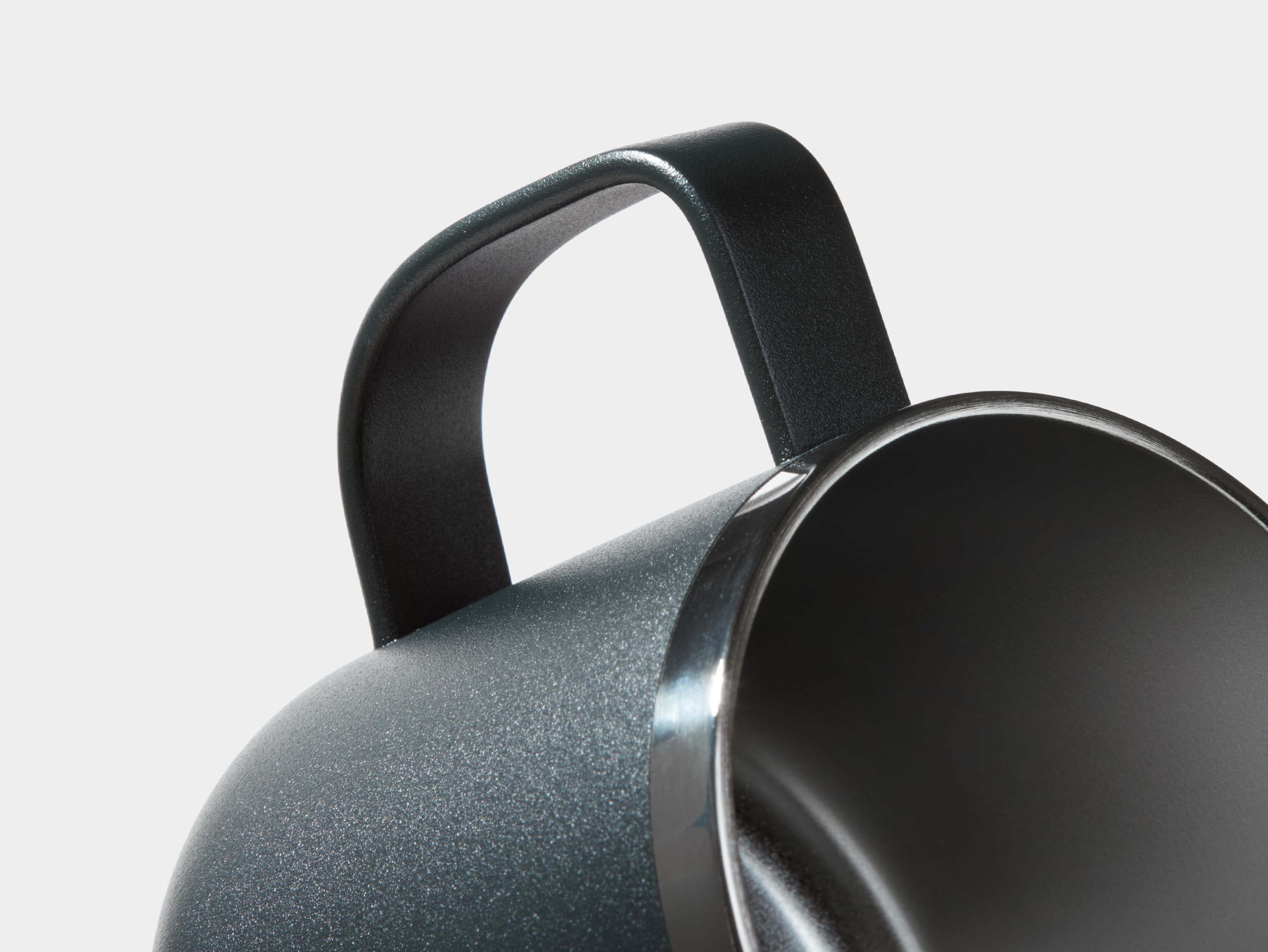 A detail image of the black insulated mug handle.