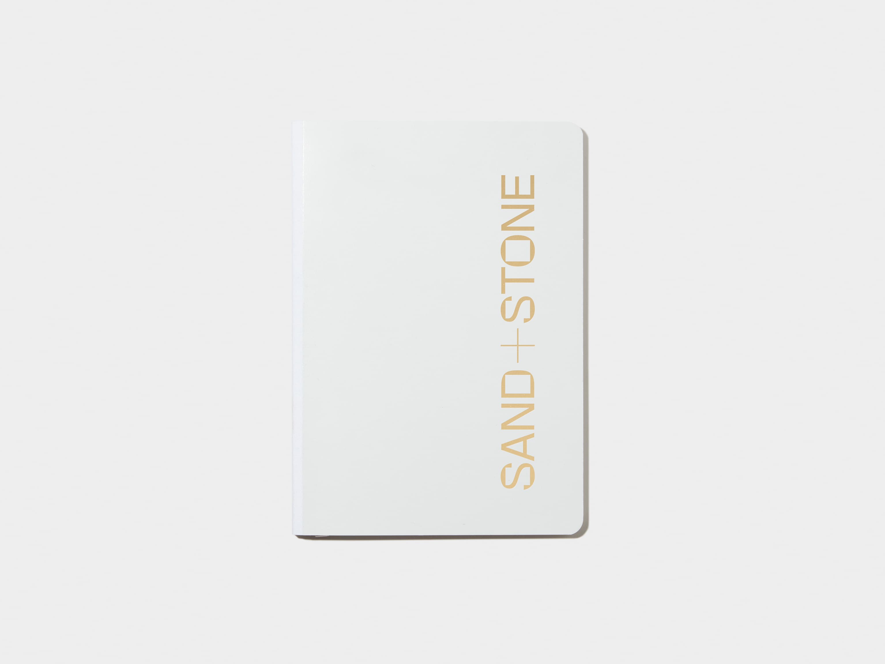 A cloudy grey softcover notebook with gold foil customisation.