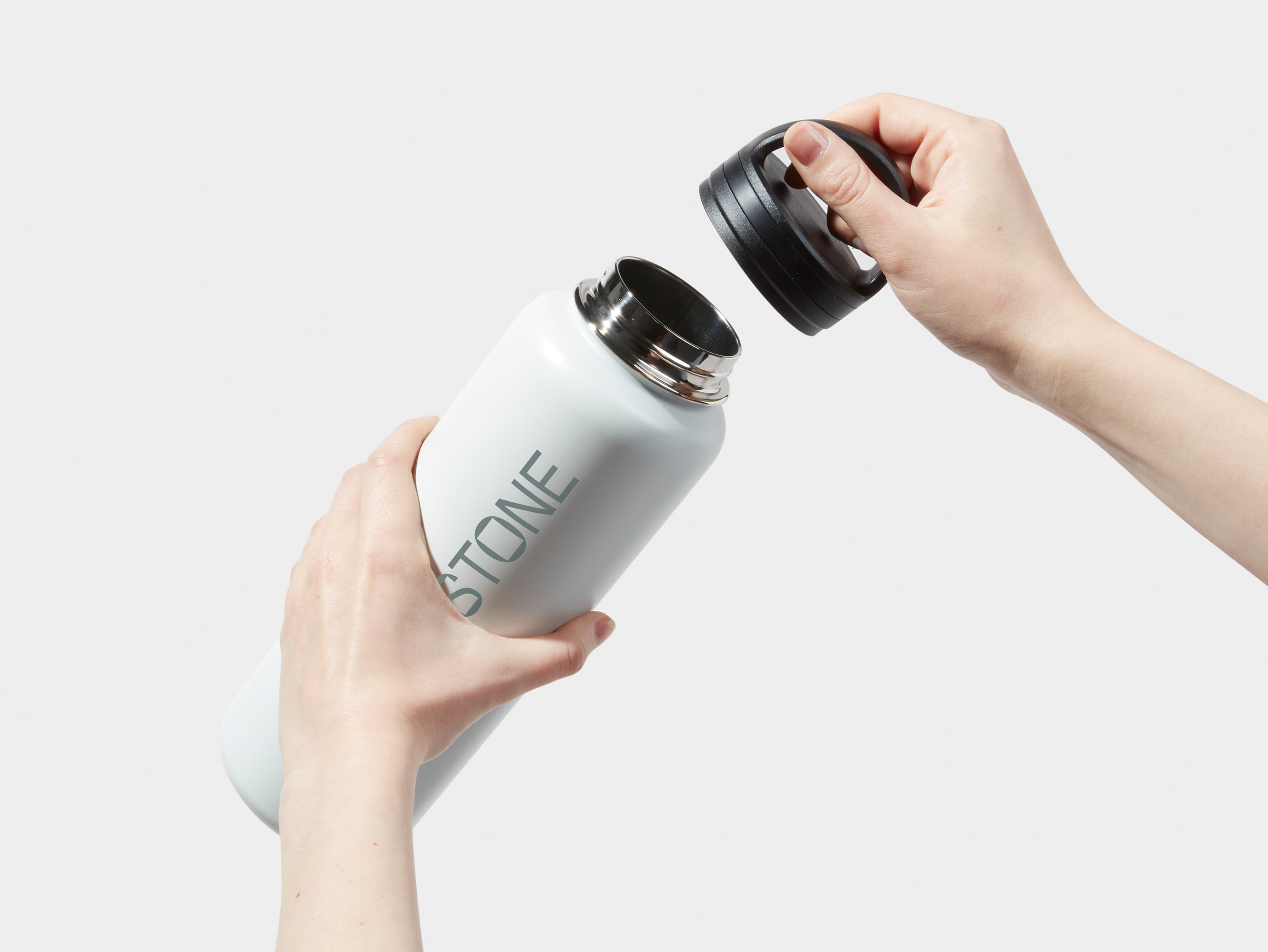 Two hands taking off the lid of a XL Insulated Water Bottle in Cloudy Grey with 360 wrap printing customisation