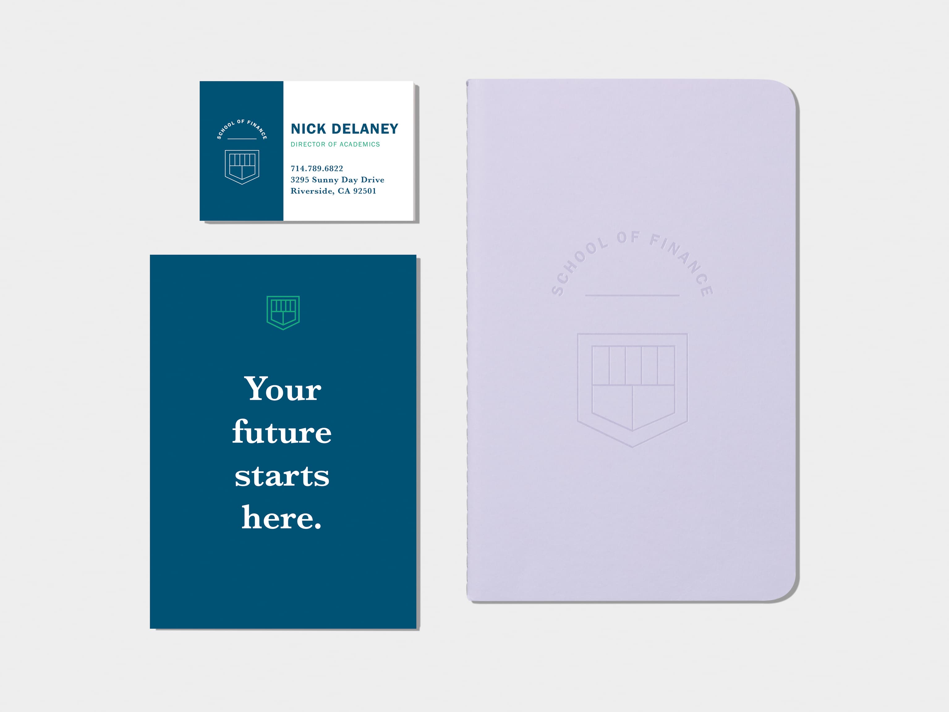 A flyer on the top left corner. Lavender soft cover journal in top right corner. A business card on bottom left corner. A mini card on bottom right corner.