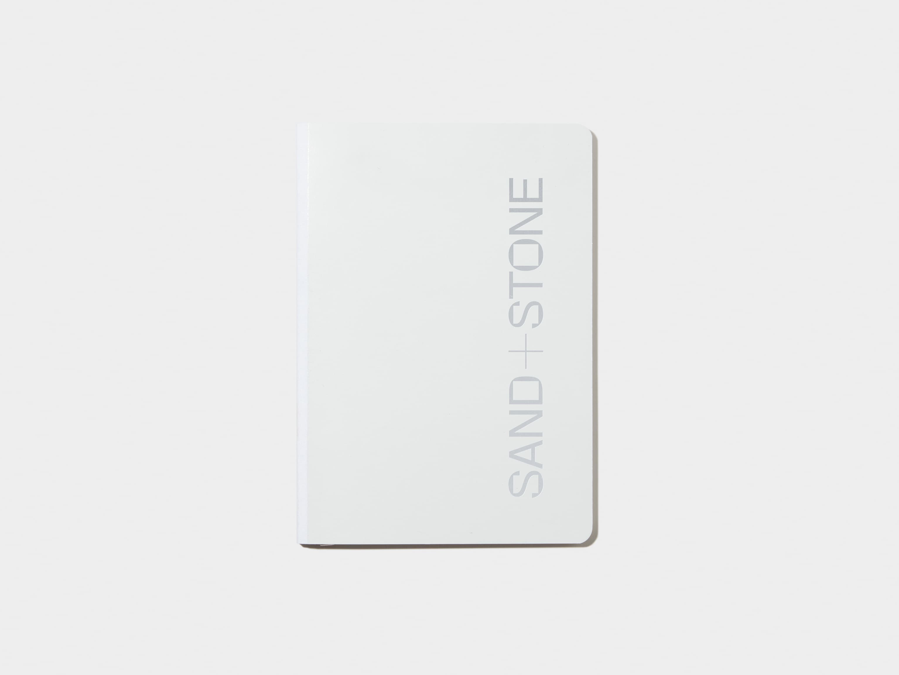 A cloudy grey softcover notebook with silver foil customisation.