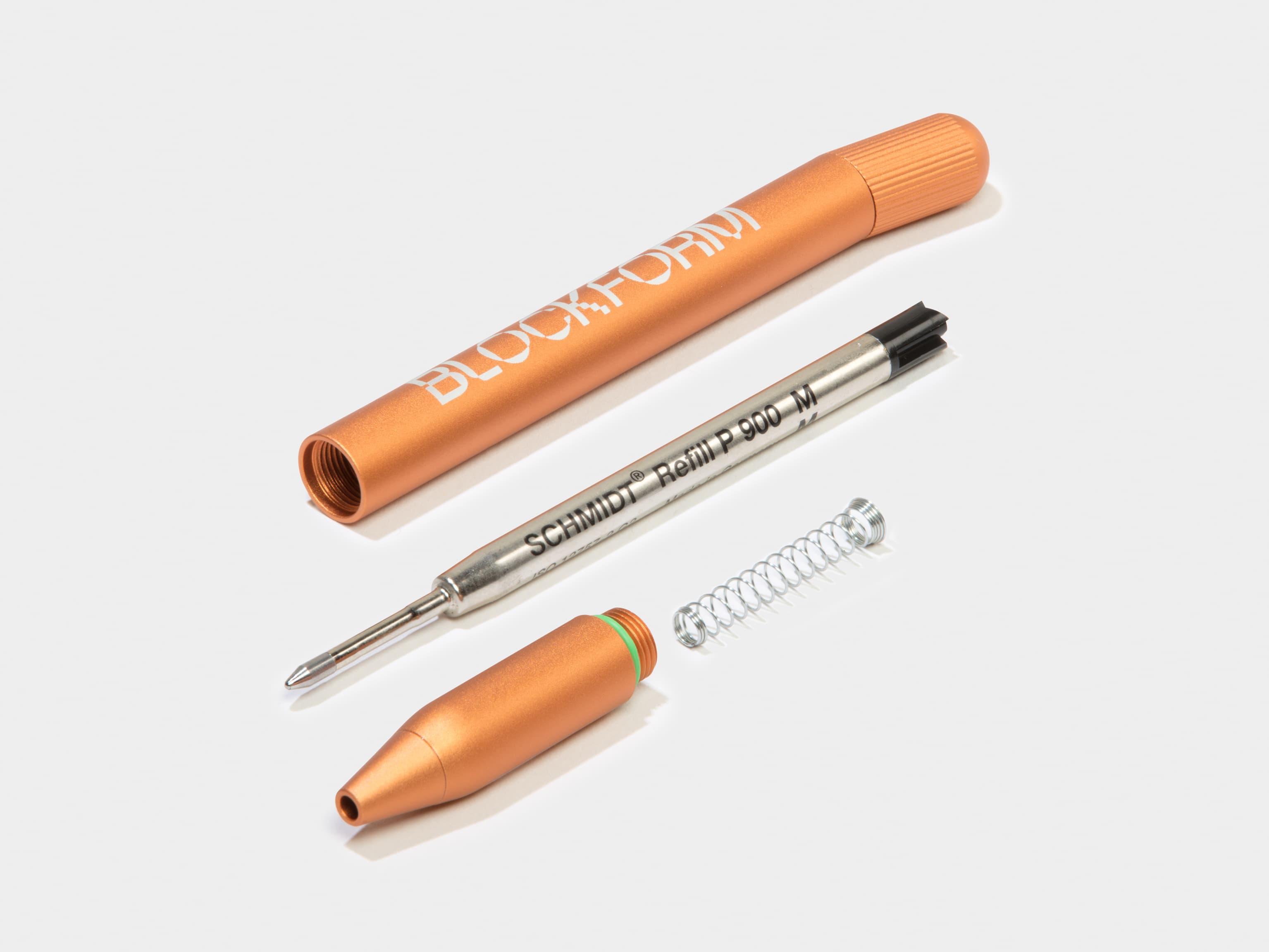 A disassembled custom orange pen.