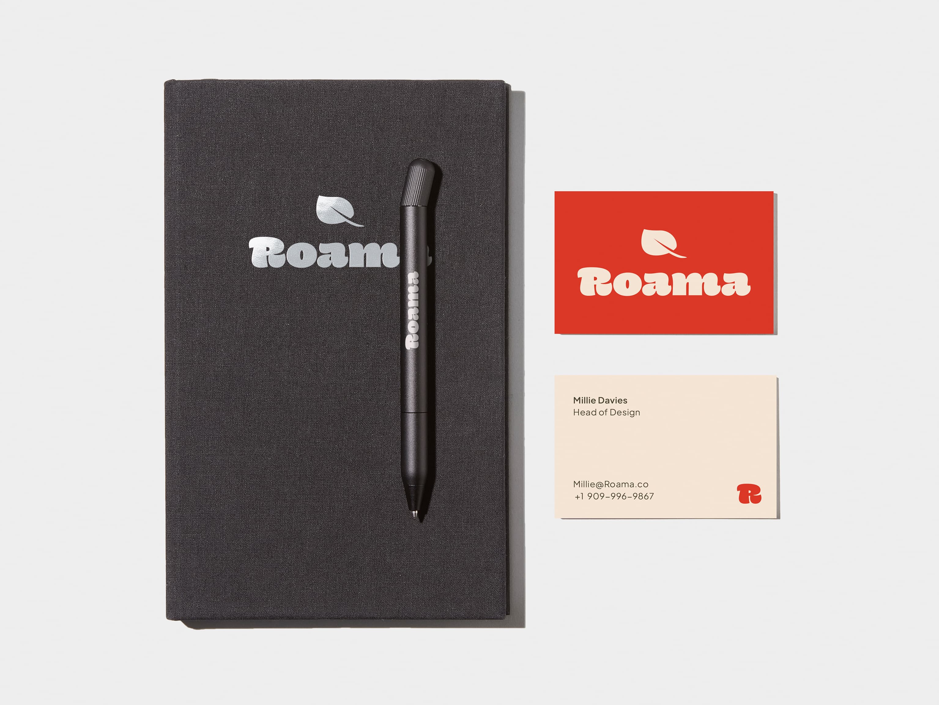 A collection of Branded Merchandise including a custom black pen and notebook.