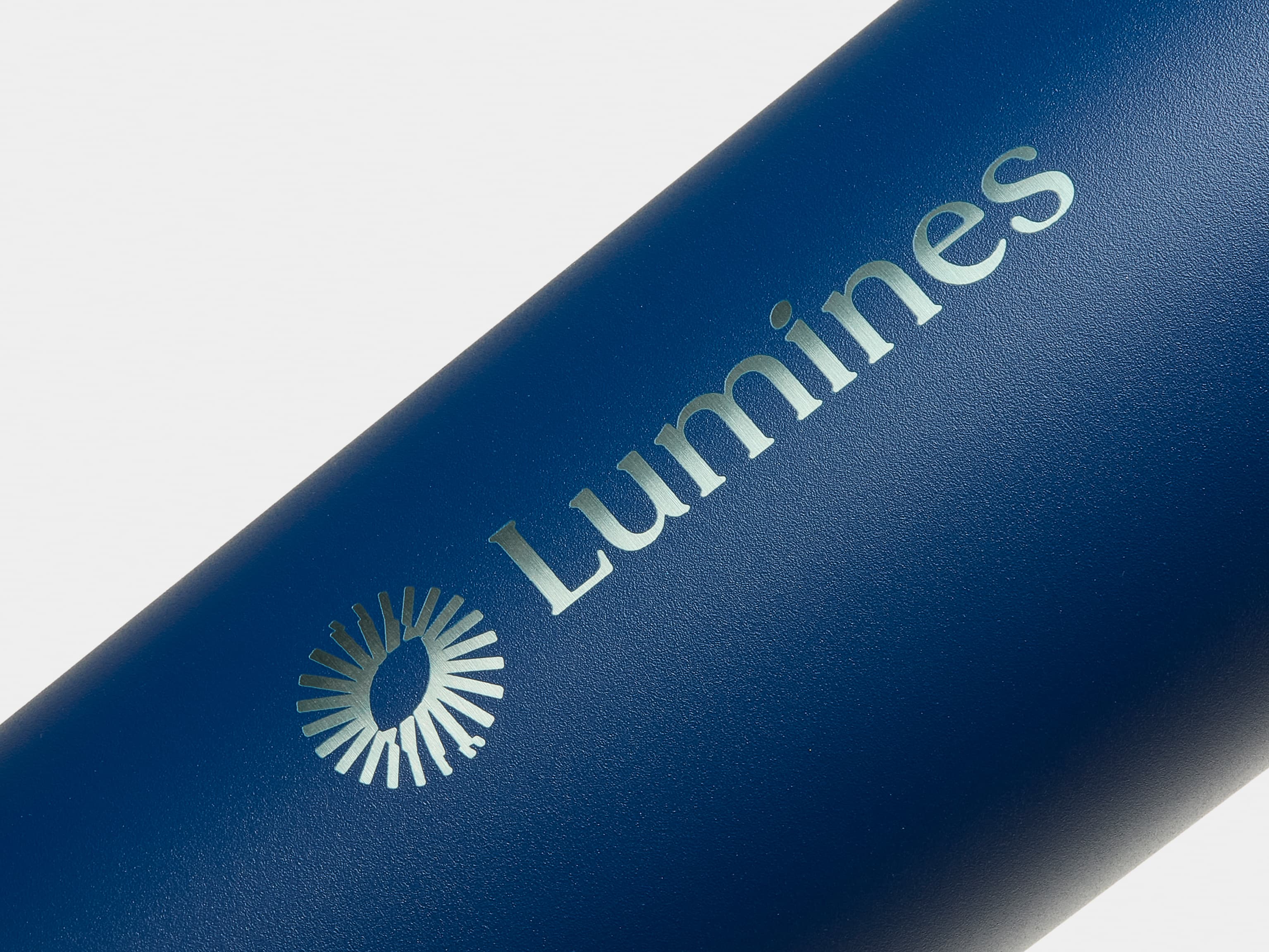 Detail image of a blue water bottle with silver custom branding.