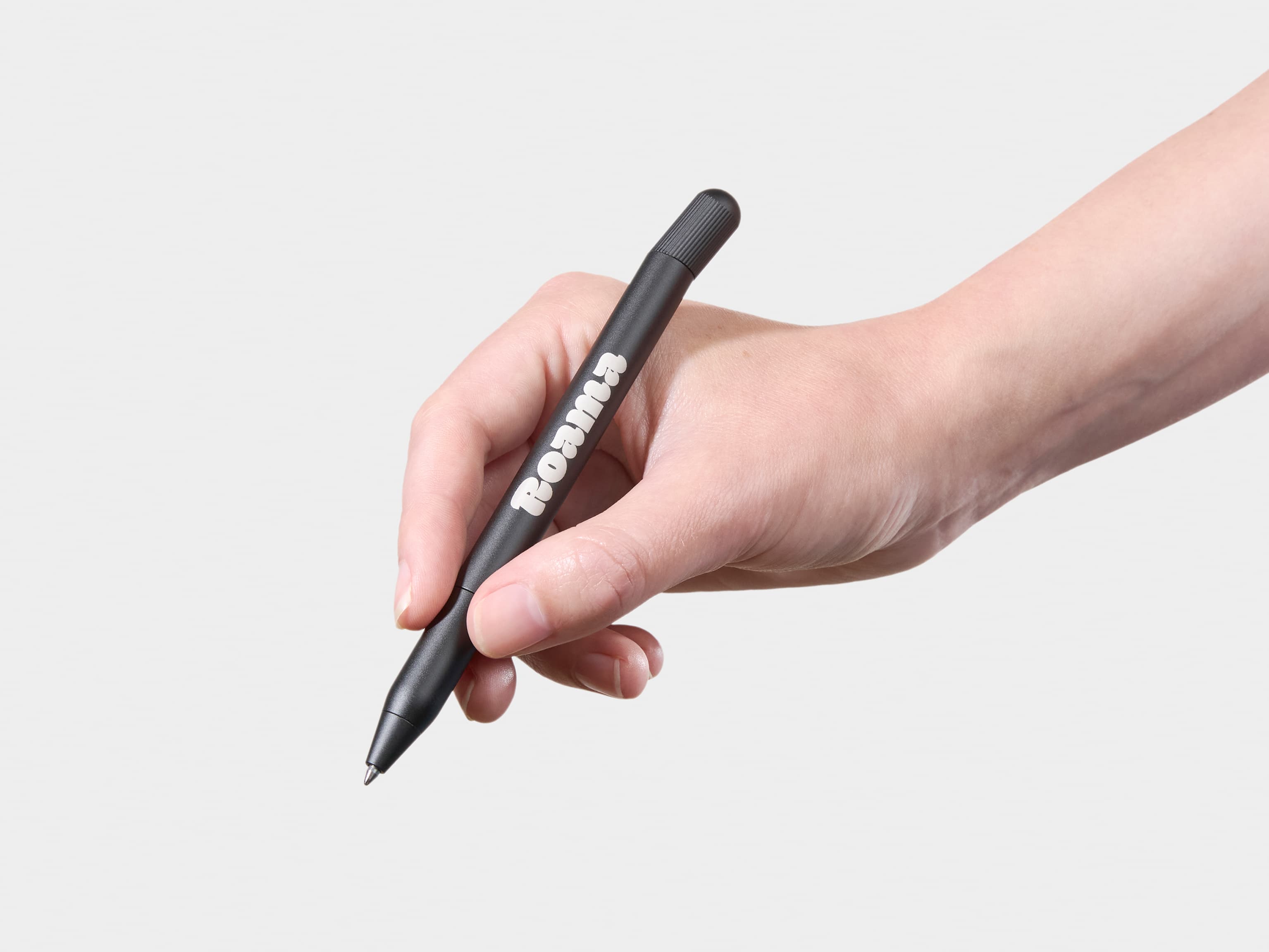 A person holding a custom black pen.