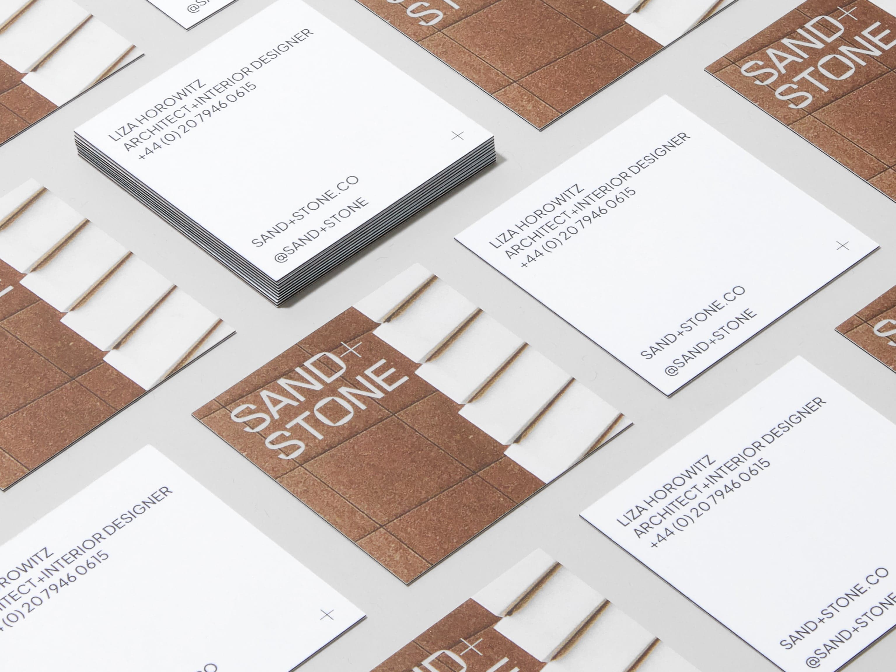 A collection of square customised luxe business cards placed across the image.