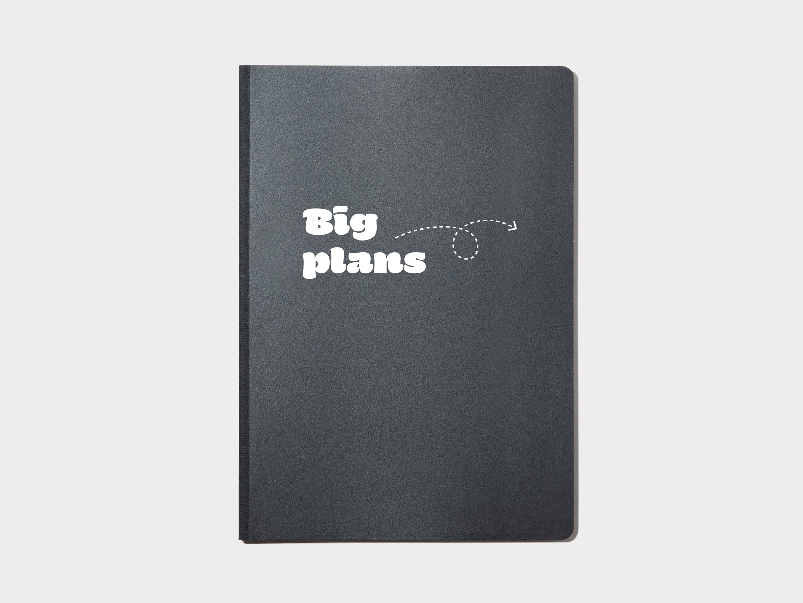 A black softcover planner with custom branding in white foil.