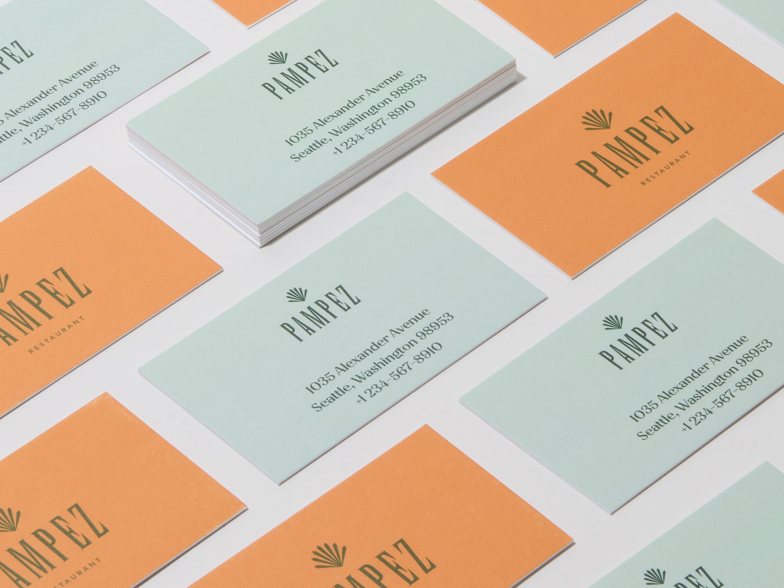 A collection of custom luxe business cards placed across the image.