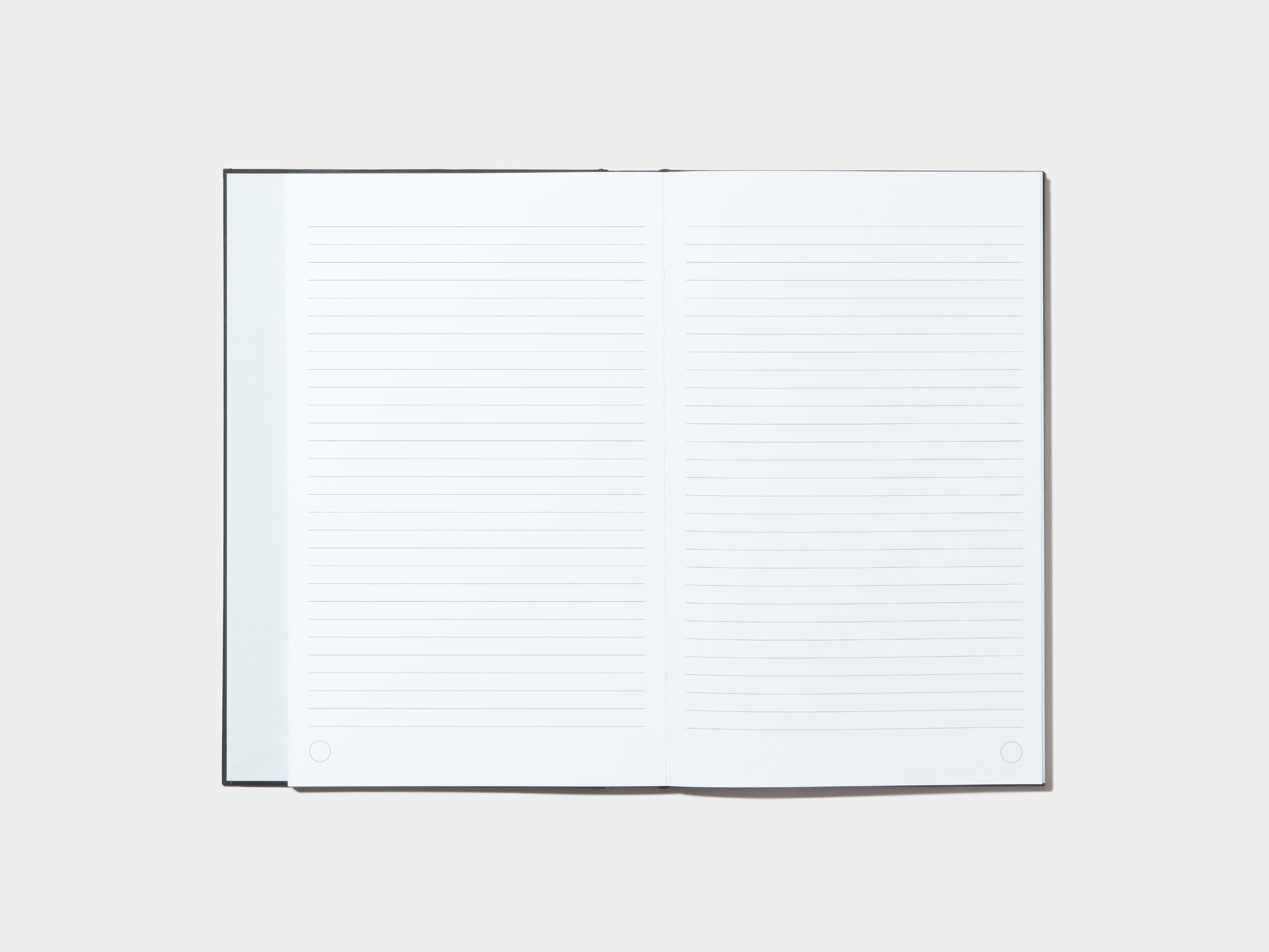 An opened Jet Black Hardcover Notebook with lined pages 