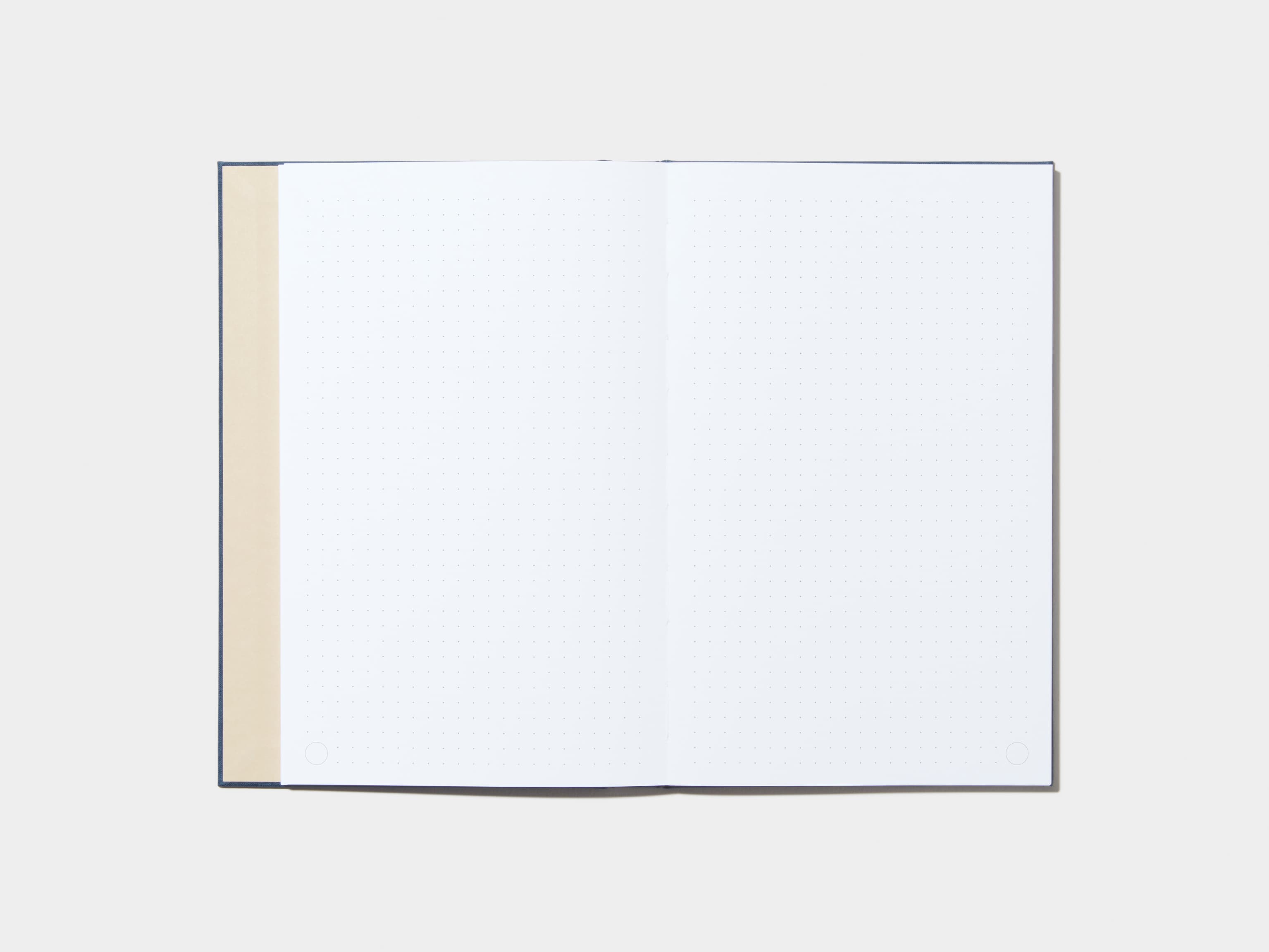 An opened Midnight Blue Hardcover Notebook with dotted pages 