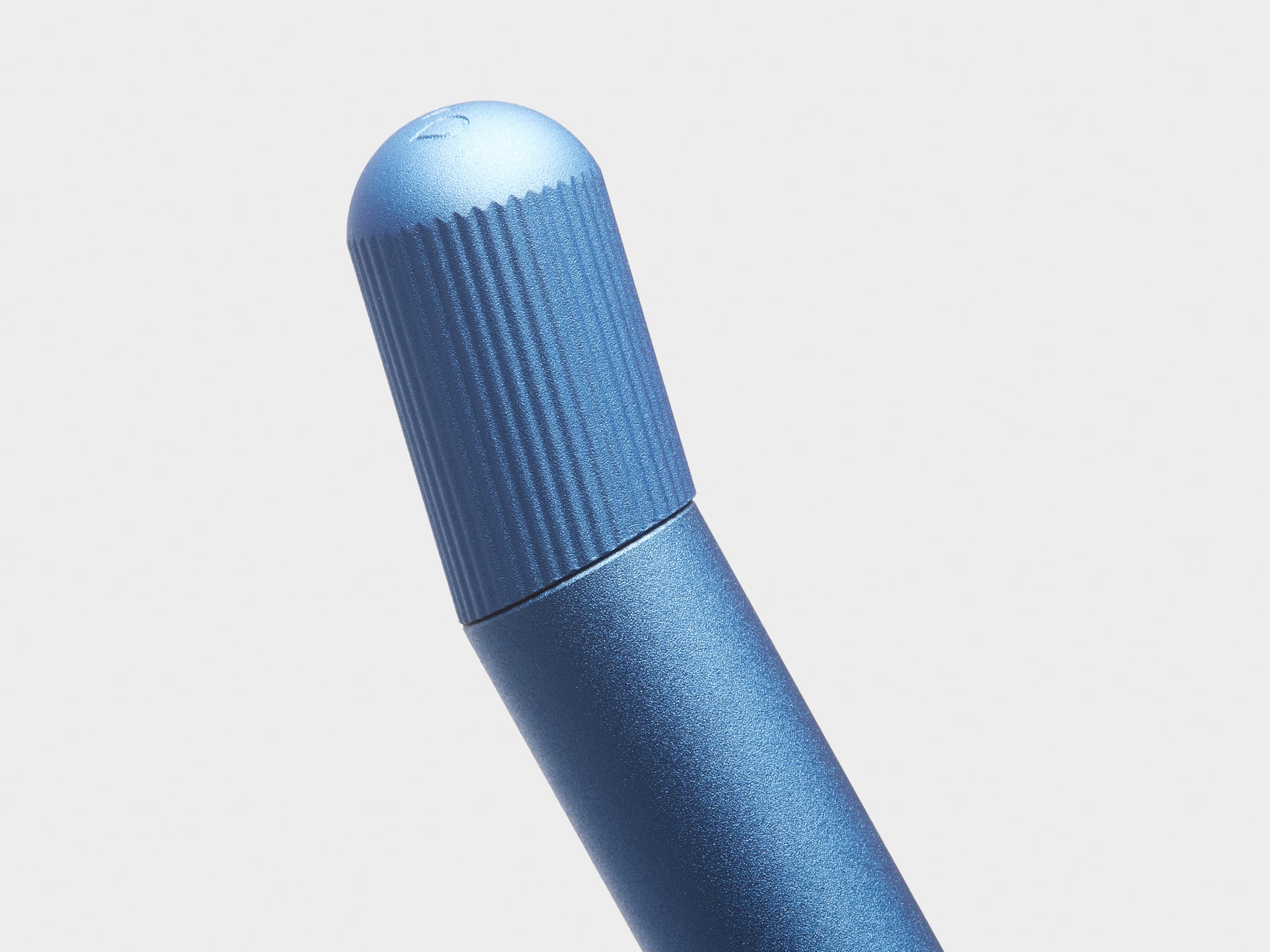 Close up of the top of a blue twist pen.