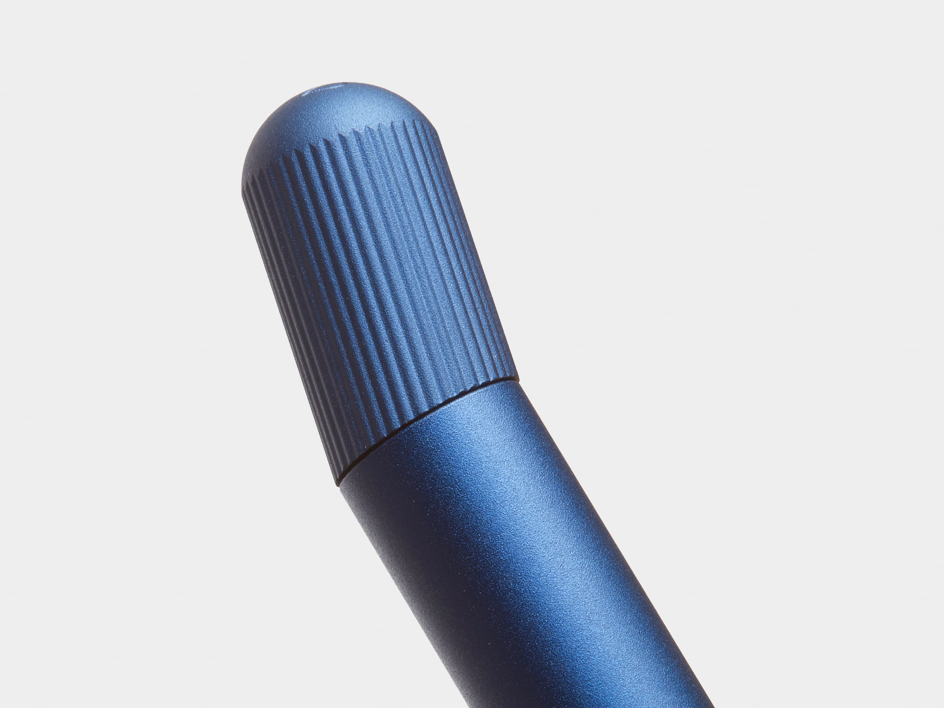 Close up of the top of a blue pen.