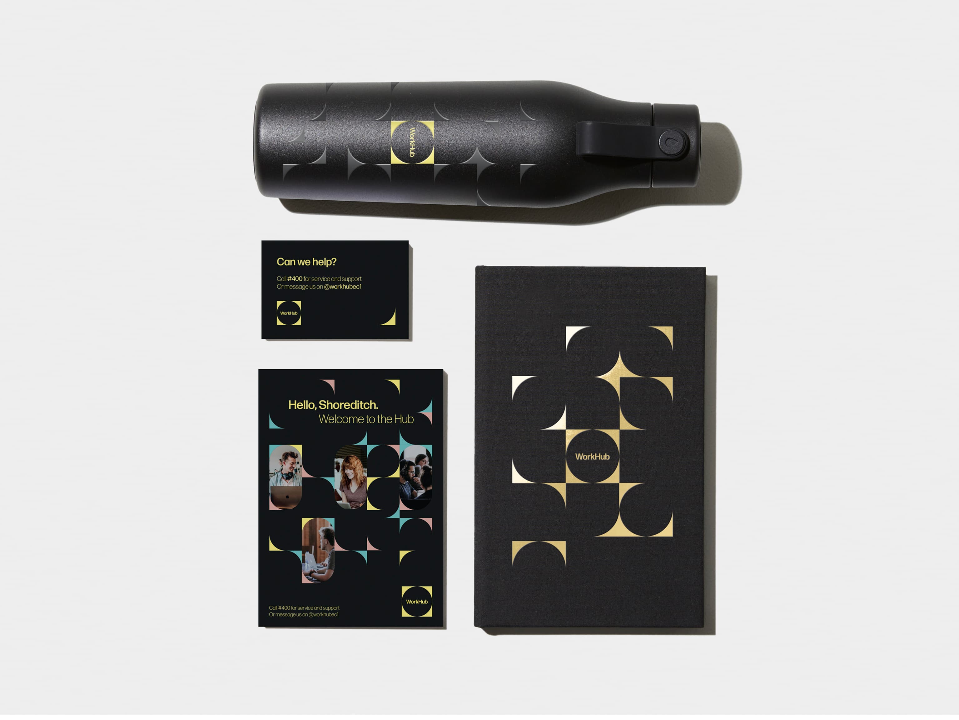 Jet Black flyer in top left corner. Hardcover Notebook with White Foil Pattern in top right corner. A business card with green details in bottom left corner. An Jet Black water bottle with coloured pattern in bottom right corner.  