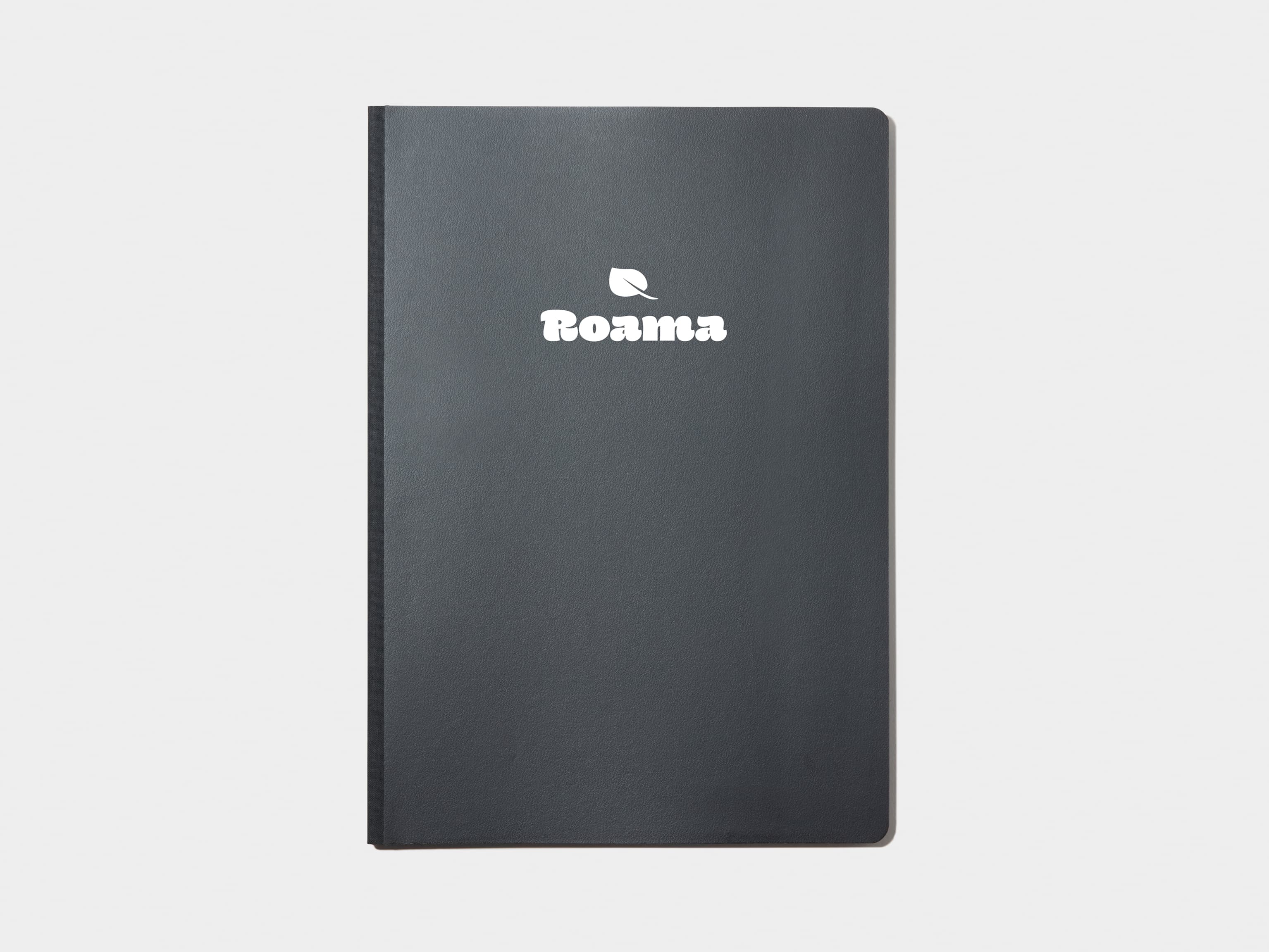 A large jet black softcover notebook with white foil customisation.