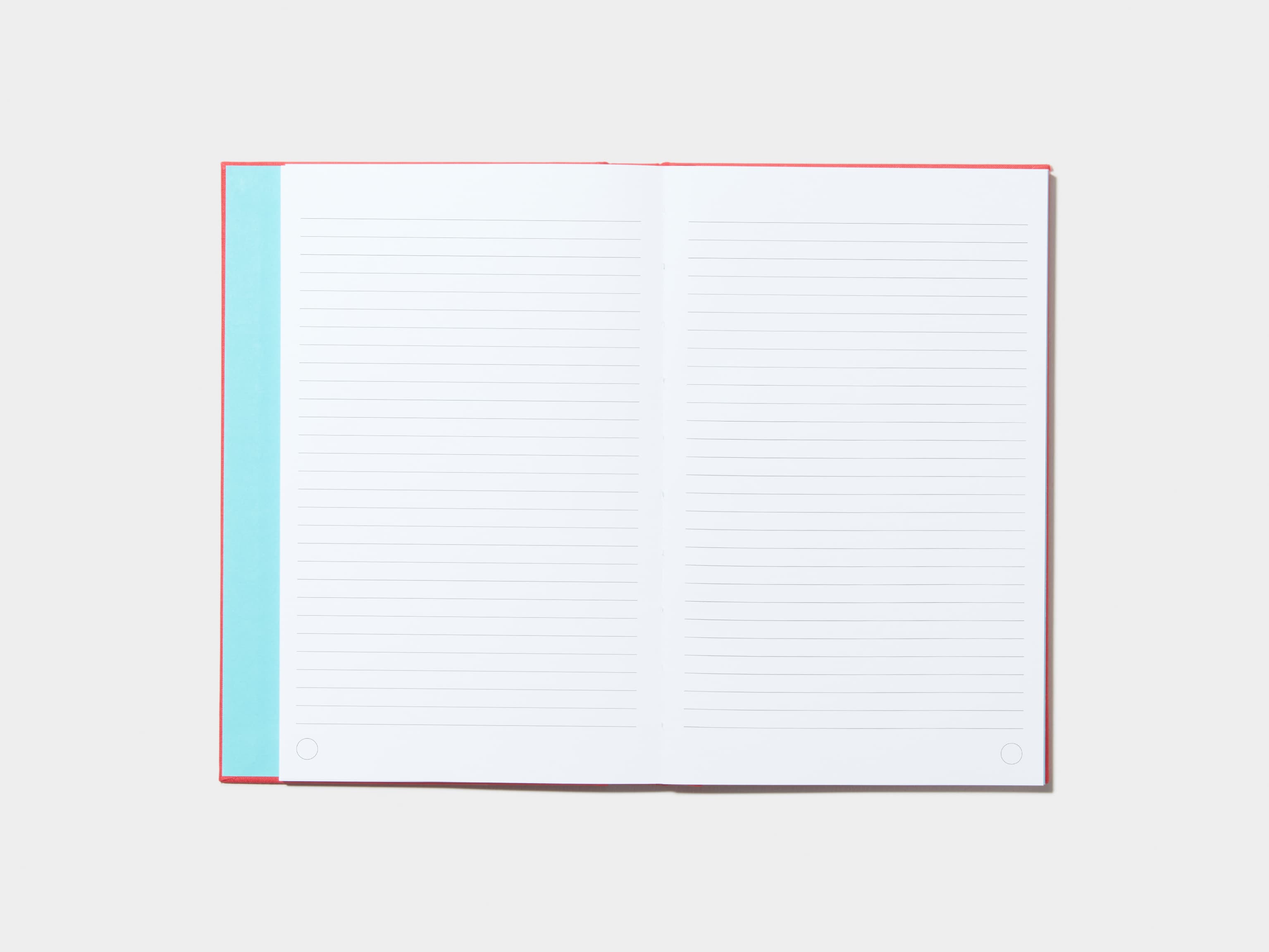 An opened Berry Red Hardcover Notebook with lined pages 