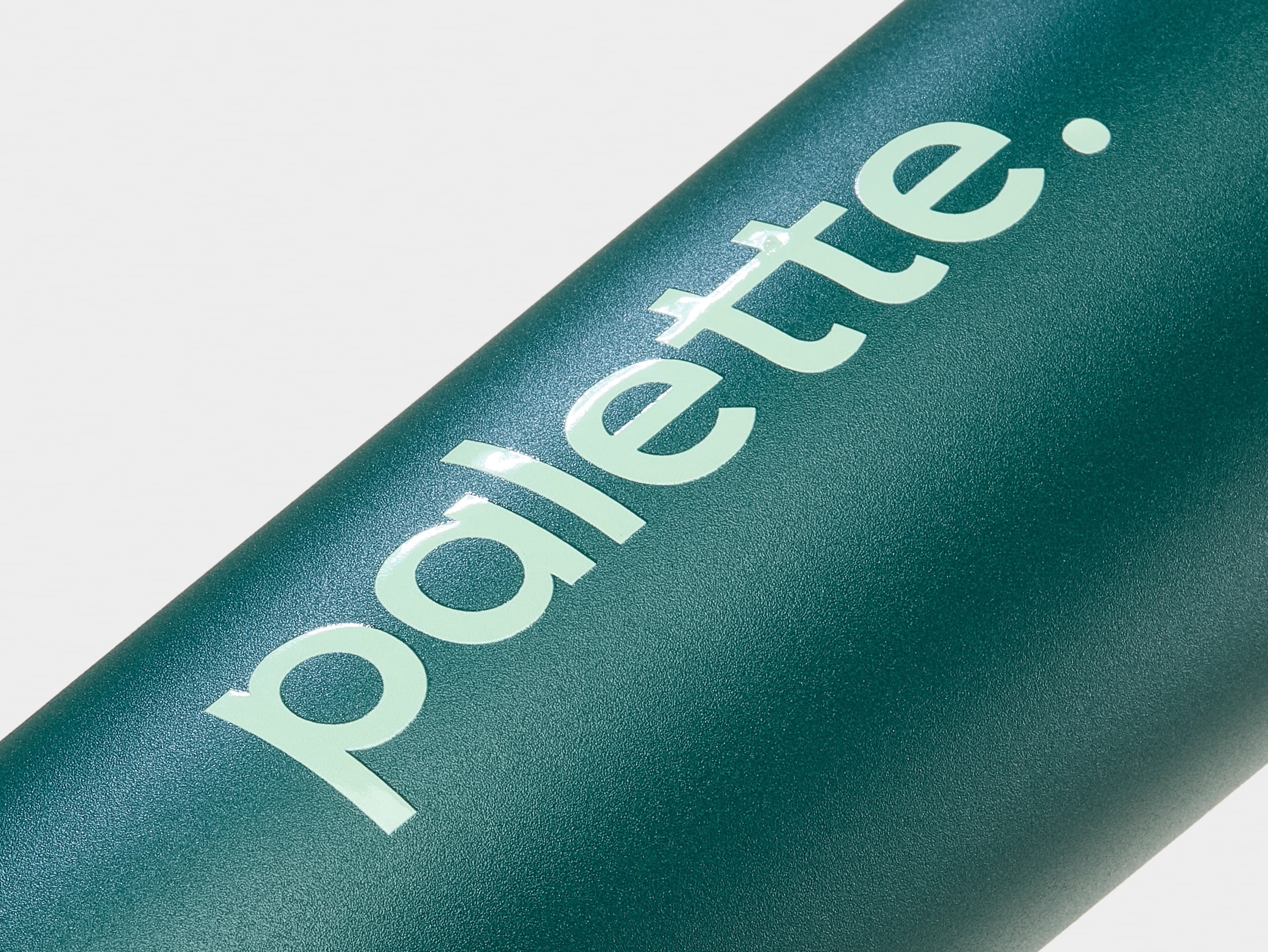 A detail image of custom branding on a green water bottle.