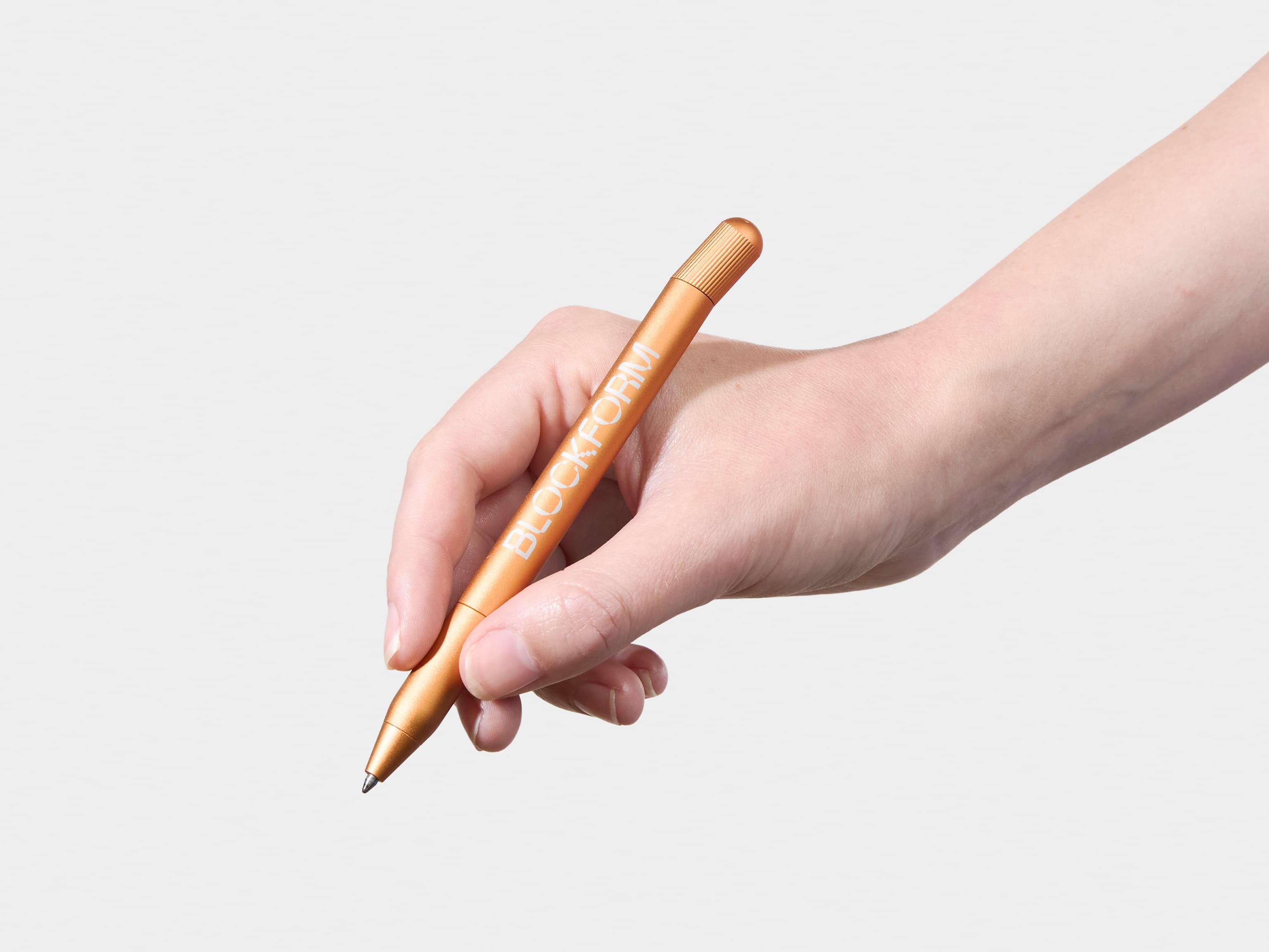 Person holding a custom orange pen.