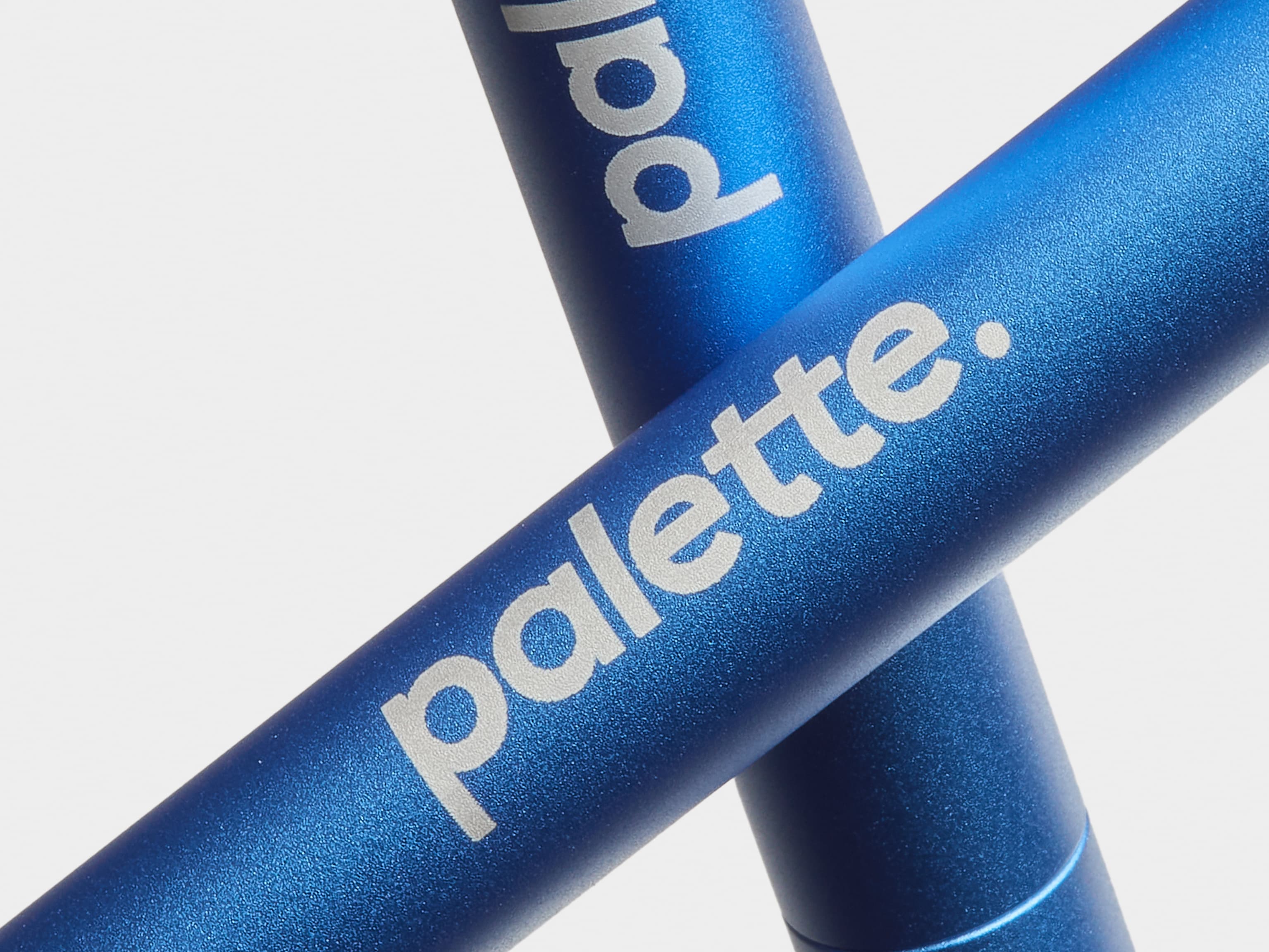 A detail image of two custom blue pens crossed over each other.