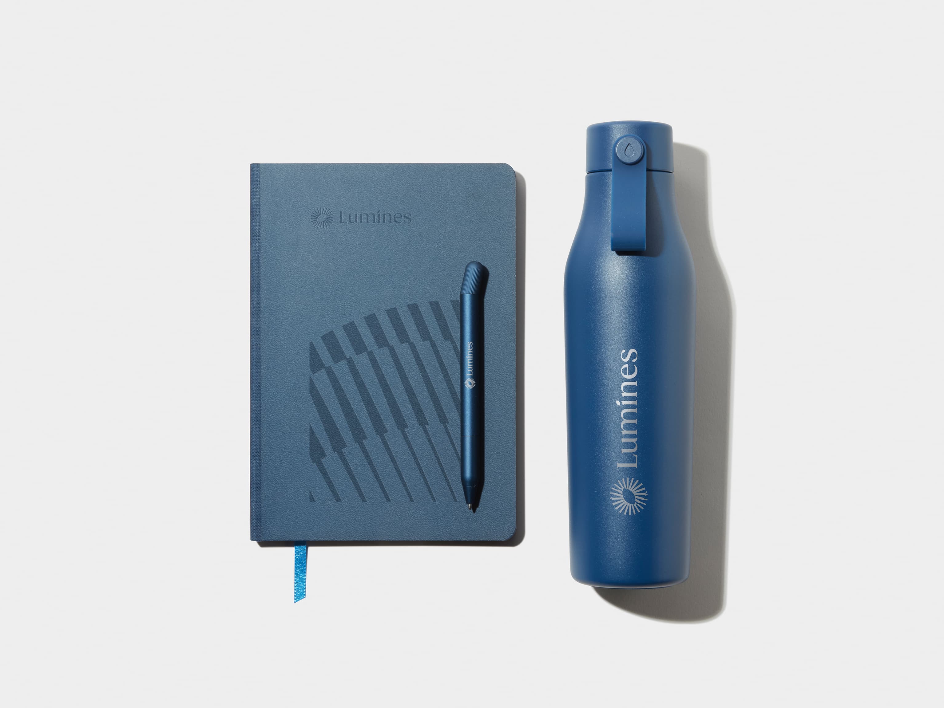 Medium Midnight Blue MOO Softcover Notebook with Blind Deboss finish alongside the MOO Twist Pen and Water Bottle 