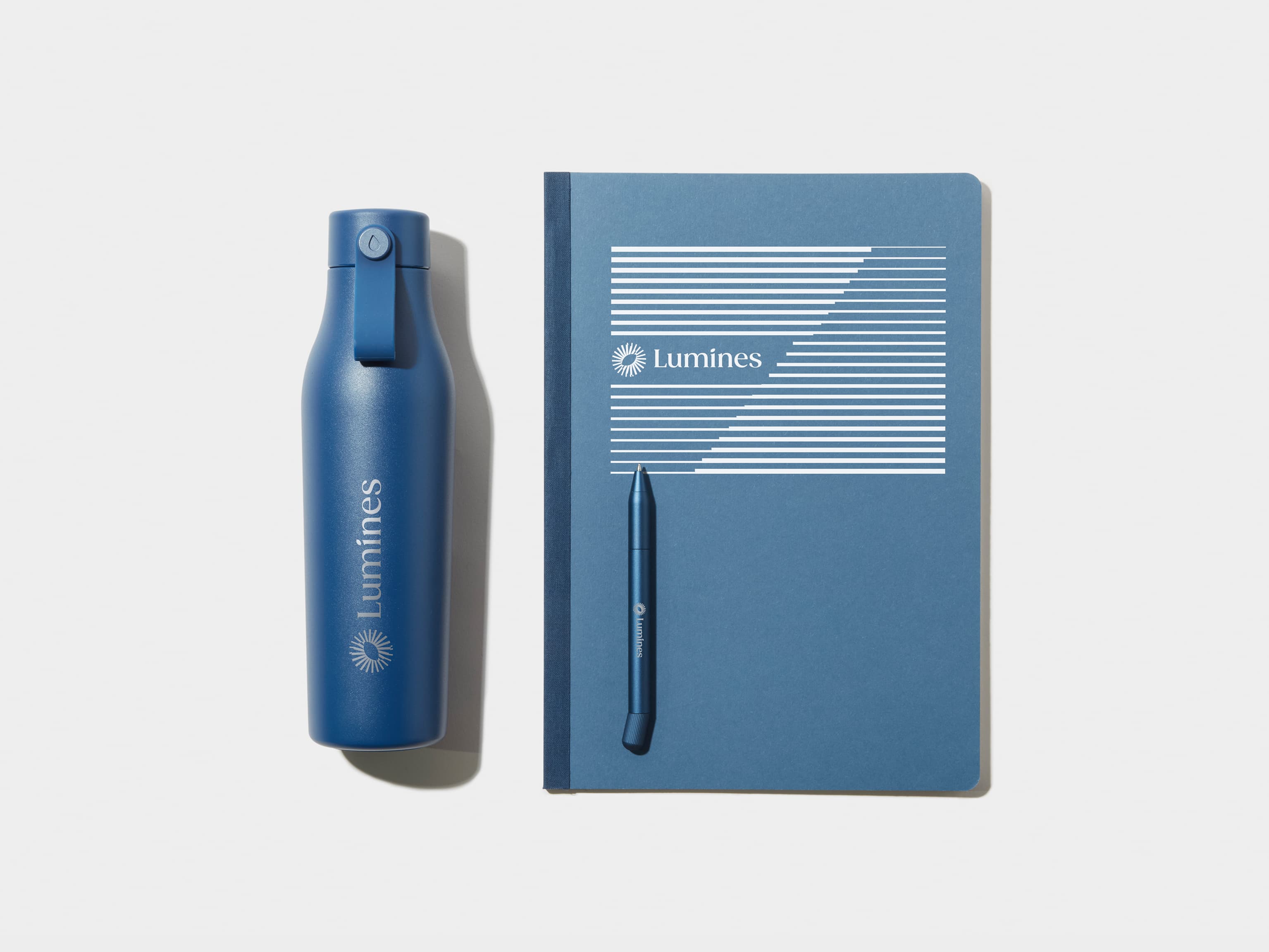 Blue Water Bottle, Blue Tape Bound Notebook and Blue Pen 