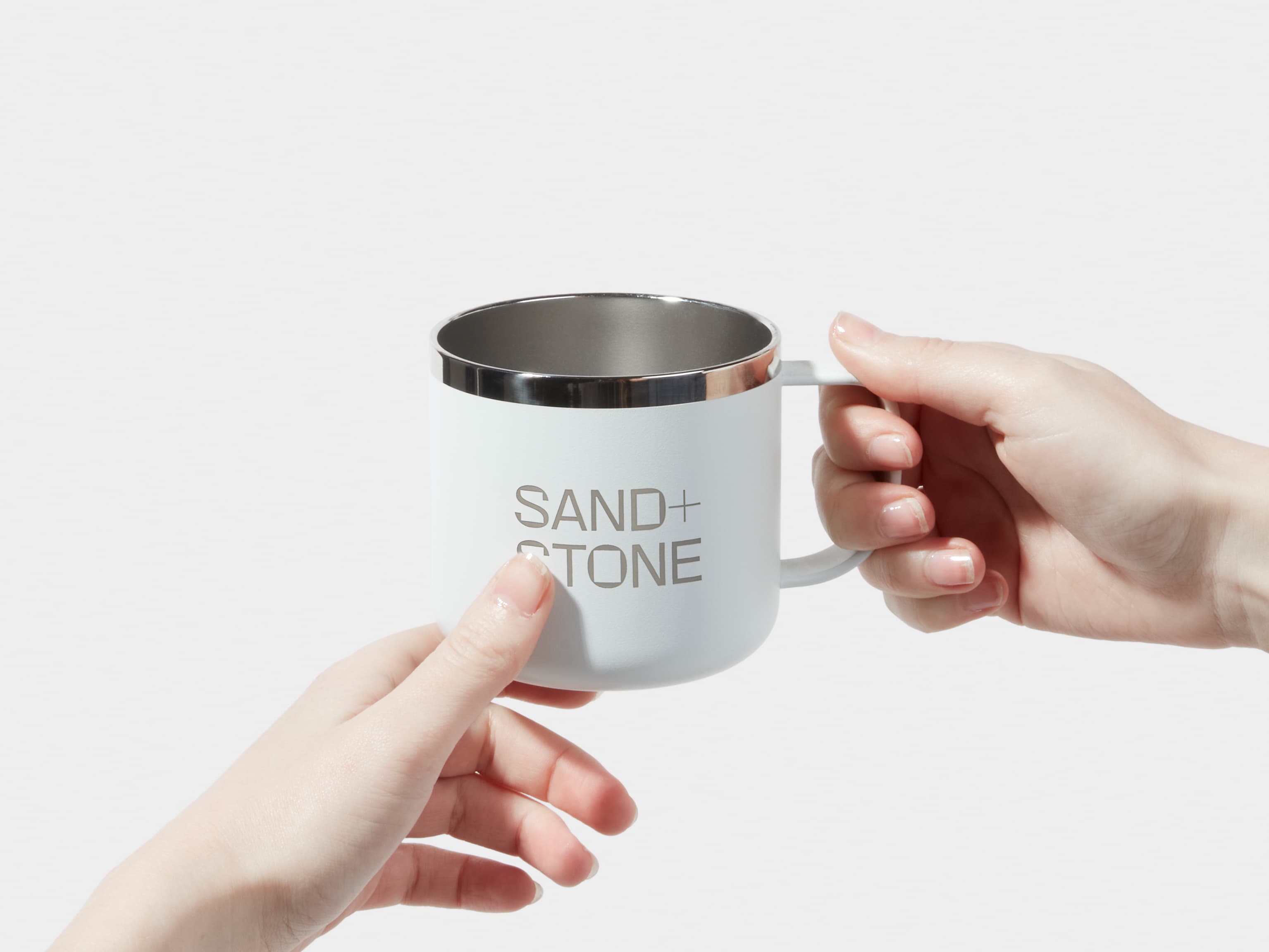 A person holding a customised cloudy grey insulated mug with two hands.