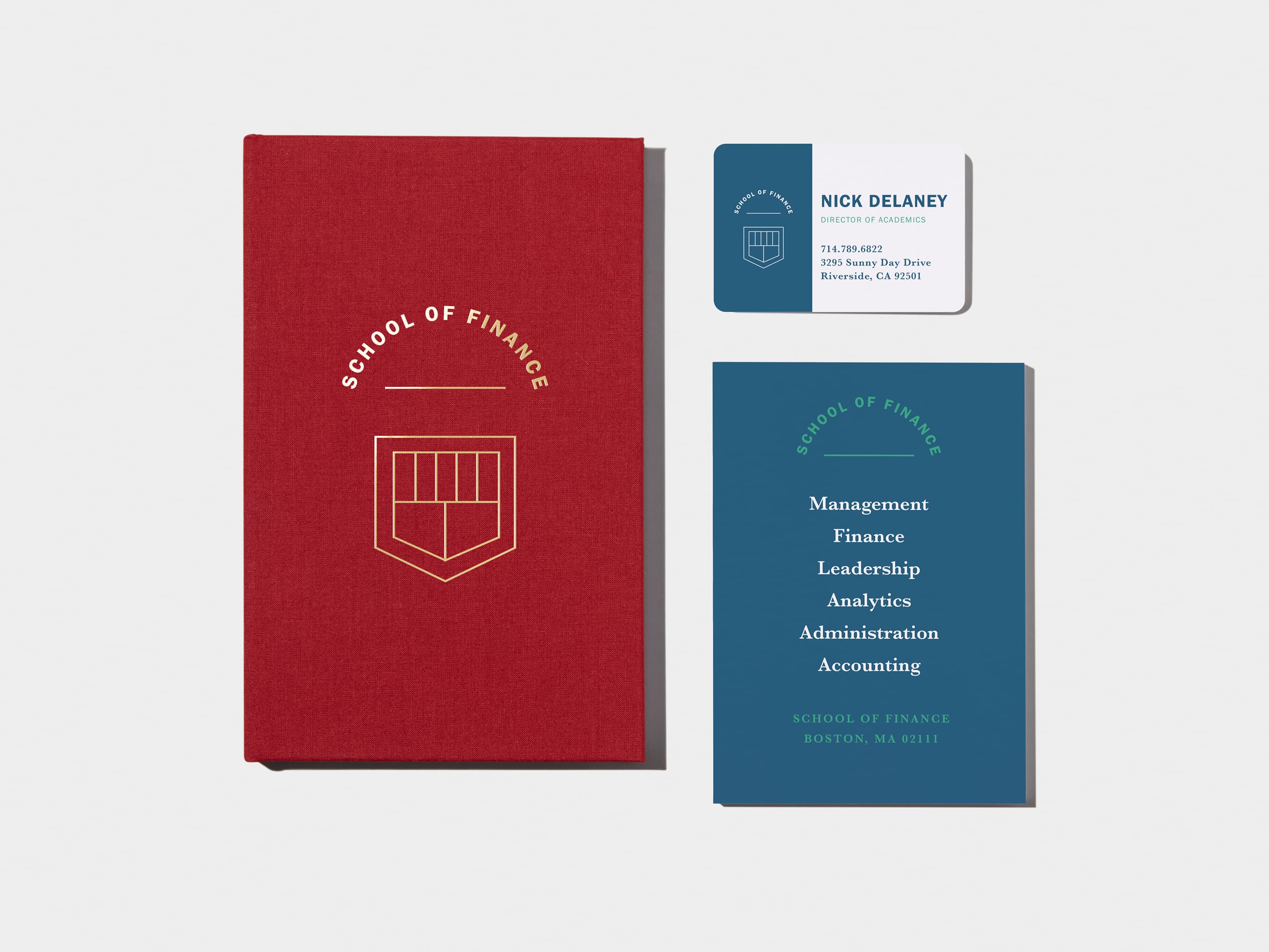 Wine Red flyer in top left corner. Hardcover Notebook with White Foil Pattern in top right corner. A business card with green details in bottom left corner. 