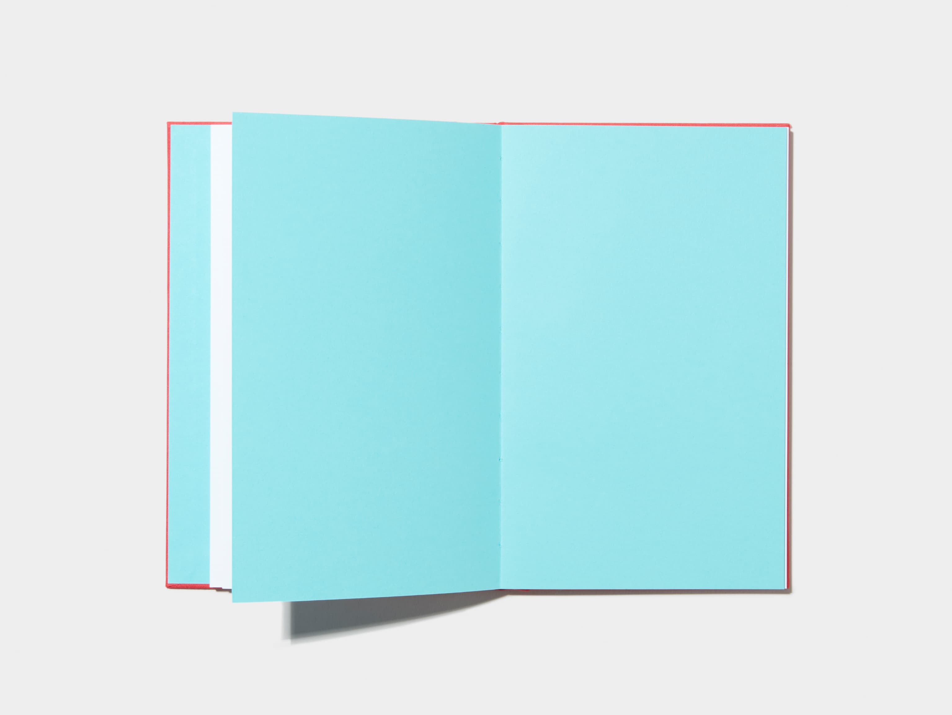 An opened Berry Red Hardcover Notebook with empty pages 