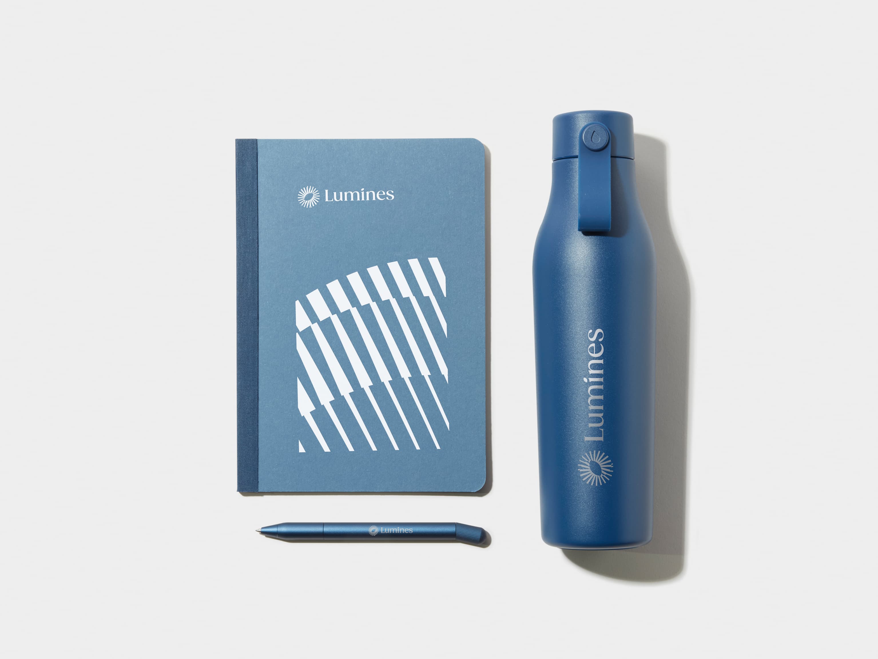 Blue Tape Bound Notebook, Blue Water Bottle and Blue Pen 